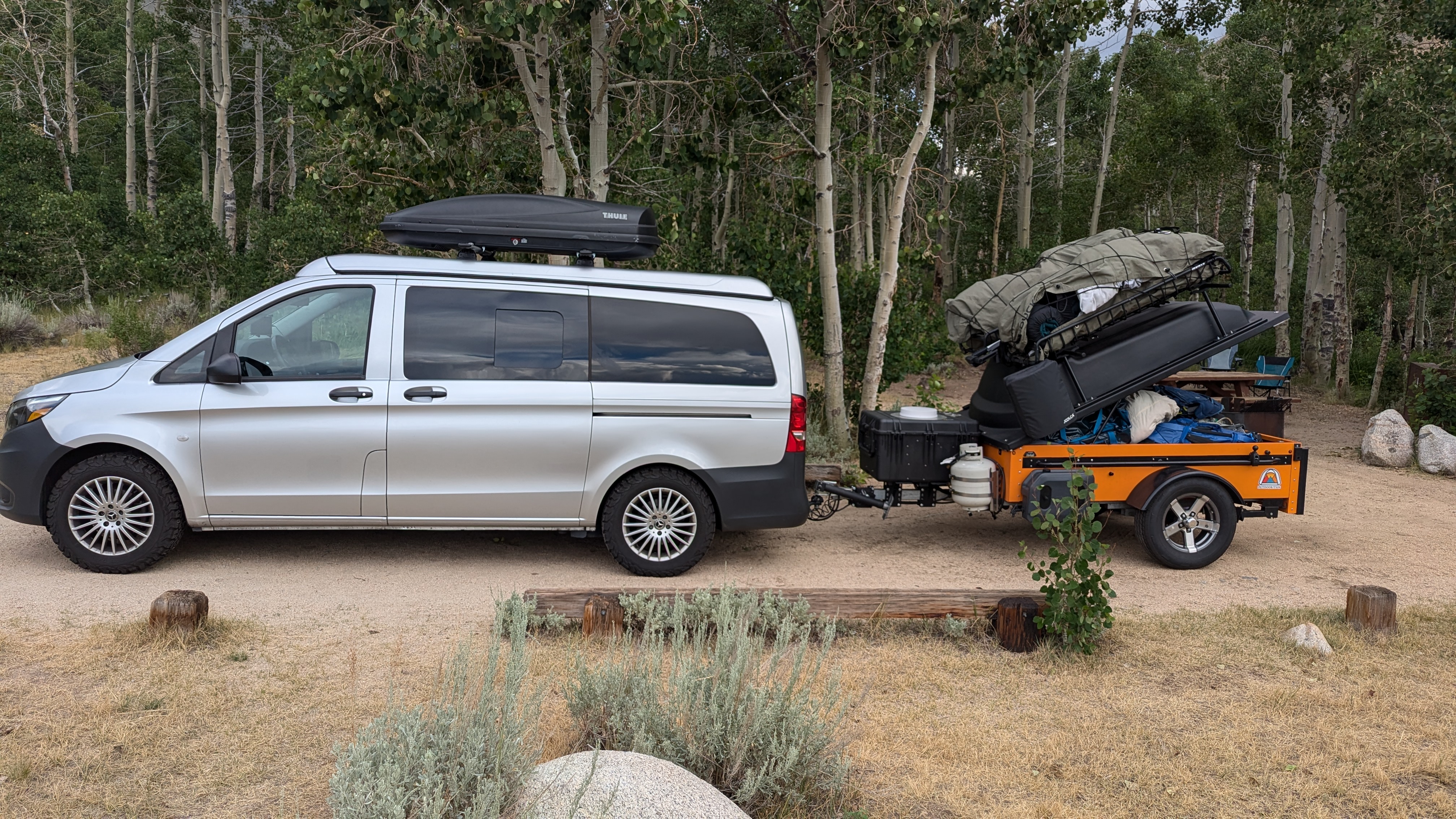 Vintage camper van with utility trailer at a campsite in the Eastern Sierra mountains