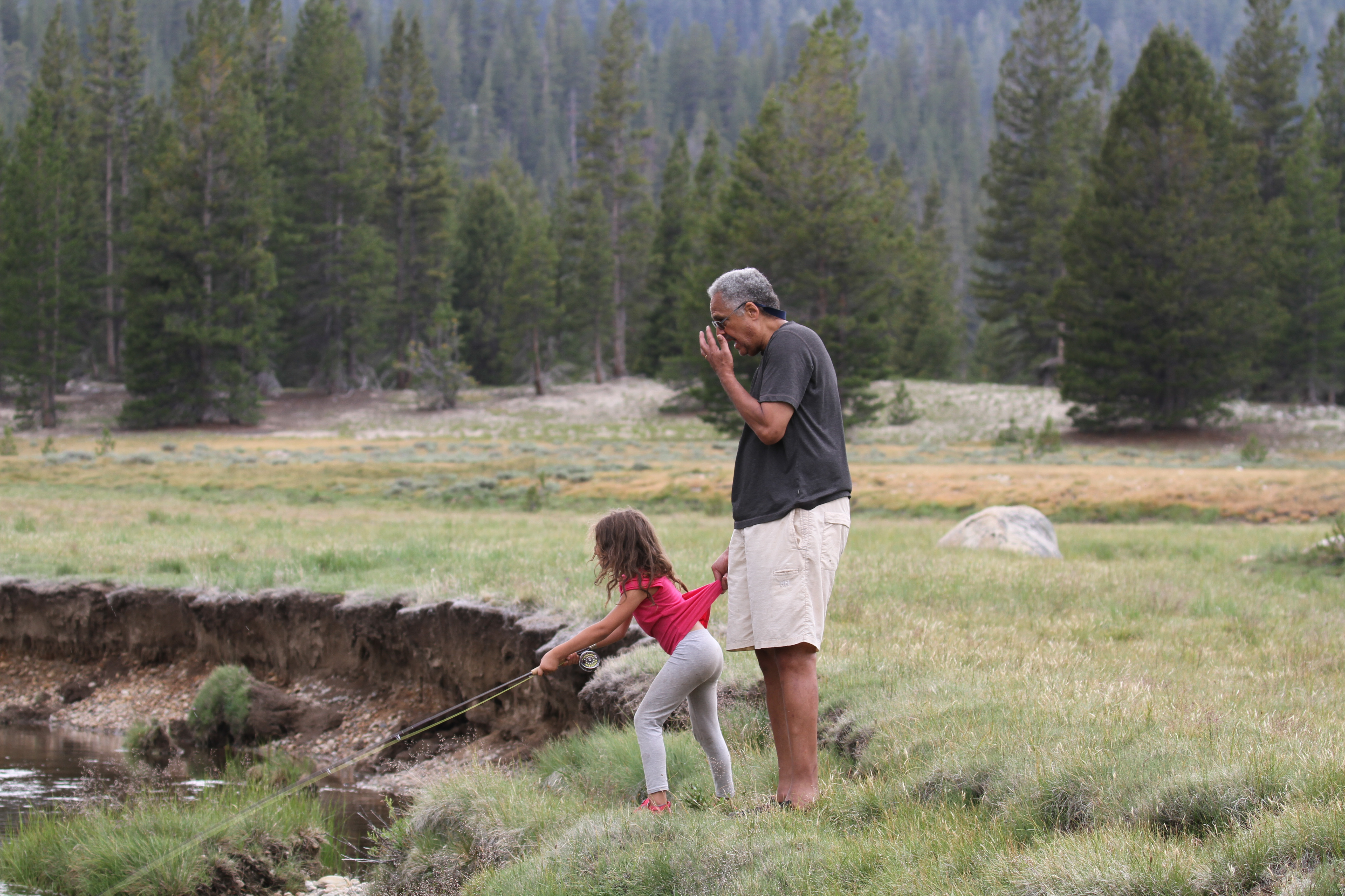 Six-year-old Siena Steele learns to fish from her grandfather at the edge of a meadow creek in Tuolumne Meadows, Yosemite National Park. Six-year-old Siena Steele learns to fish from her grandfather at the edge of a meadow creek in Tuolumne Meadows, Yosemite National Park.