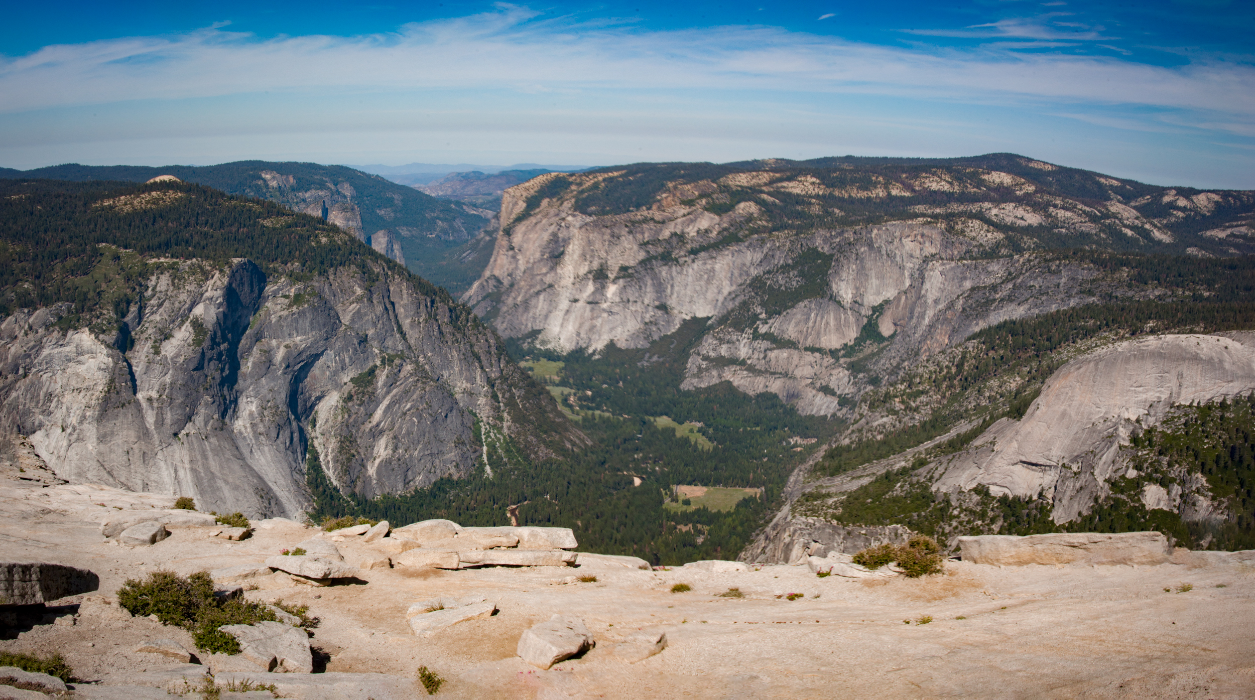 View from the summit of Half Dome looking down at Yosemite Valley with the Sierra Nevada beyond. View from the summit of Half Dome looking down at Yosemite Valley with the Sierra Nevada beyond.