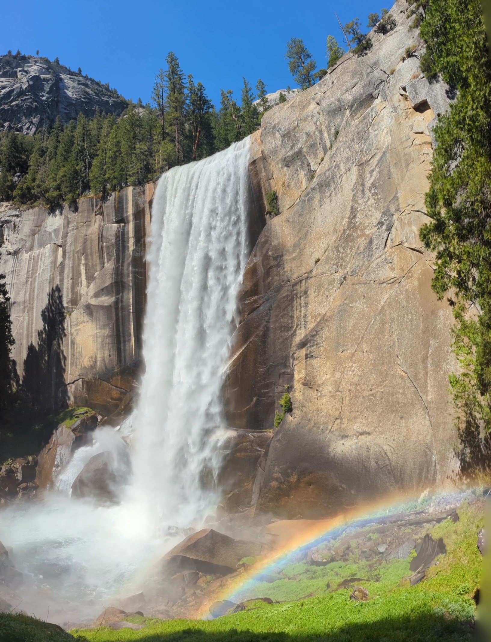 Vernal Fall in full flow with a rainbow at the base, viewed from the Mist Trail in Yosemite National Park. Vernal Fall in full flow with a rainbow at the base, viewed from the Mist Trail in Yosemite National Park.