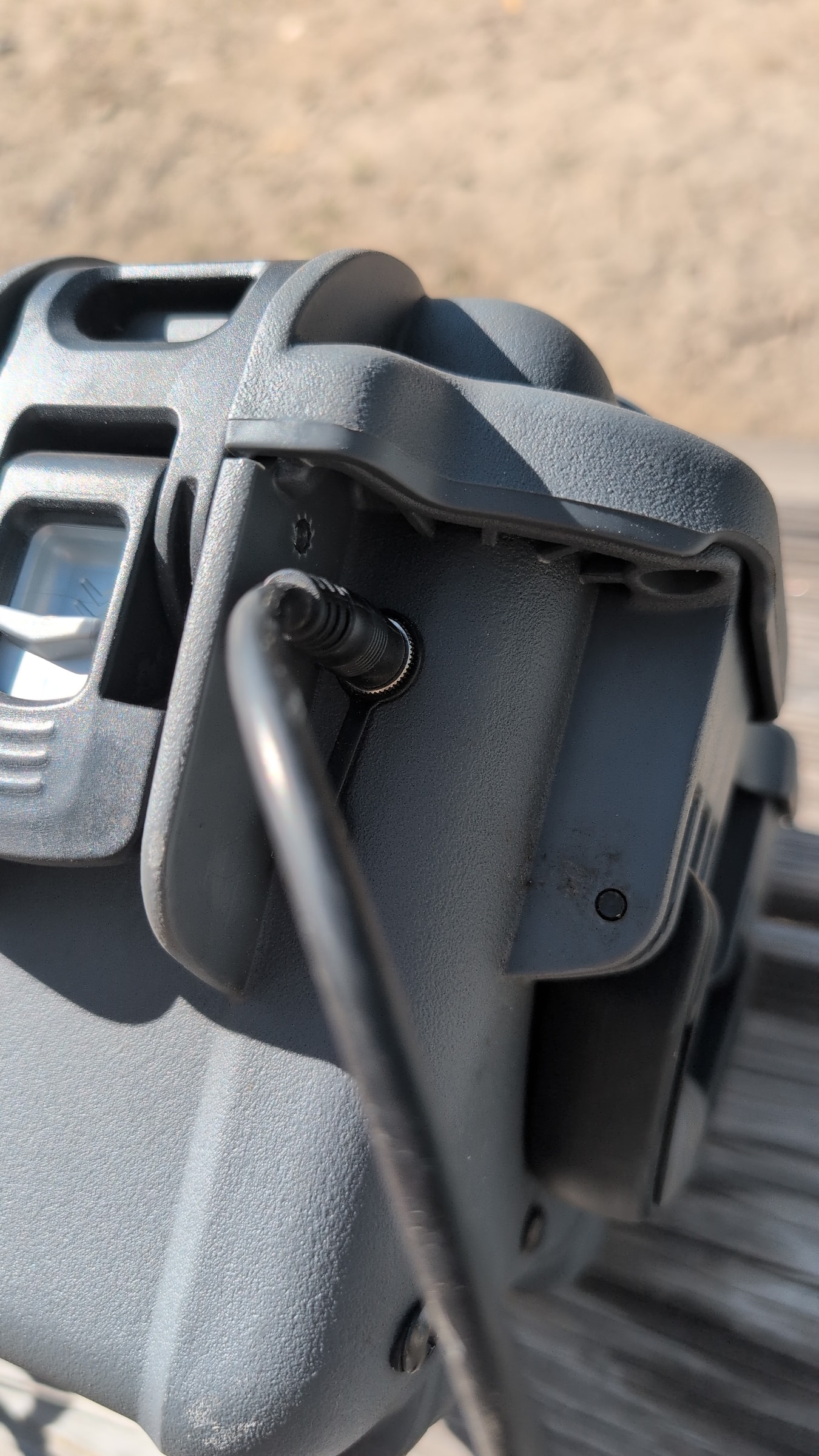 Close-up of power cord being plugged into Guzzle H2O power inlet port