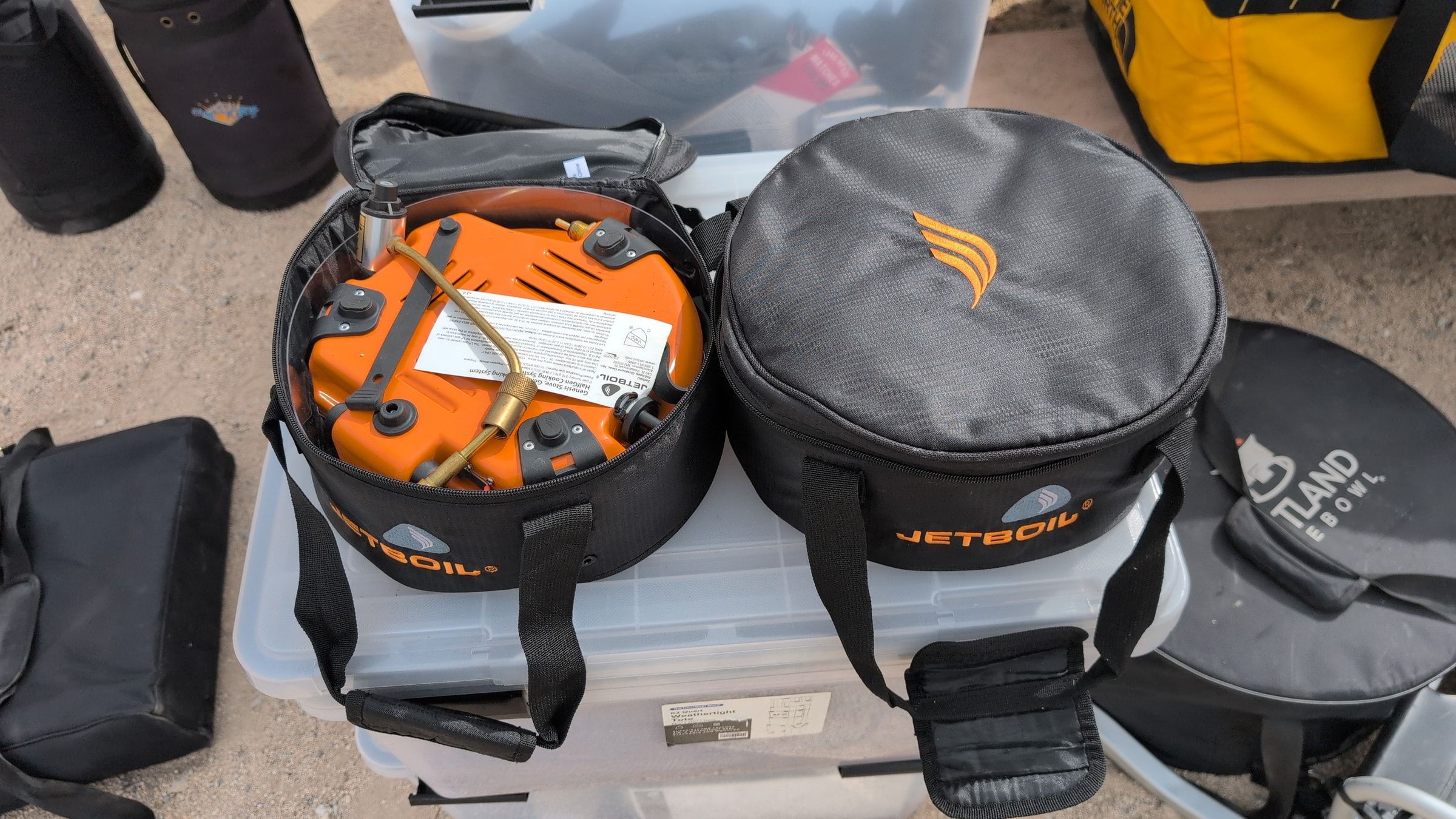 Photo of Jetboil burner cases with one orange burner visible inside