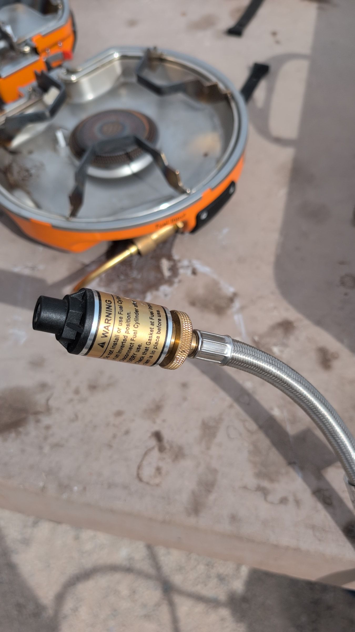 Close-up of braided hose fitting ready to attach to the burner