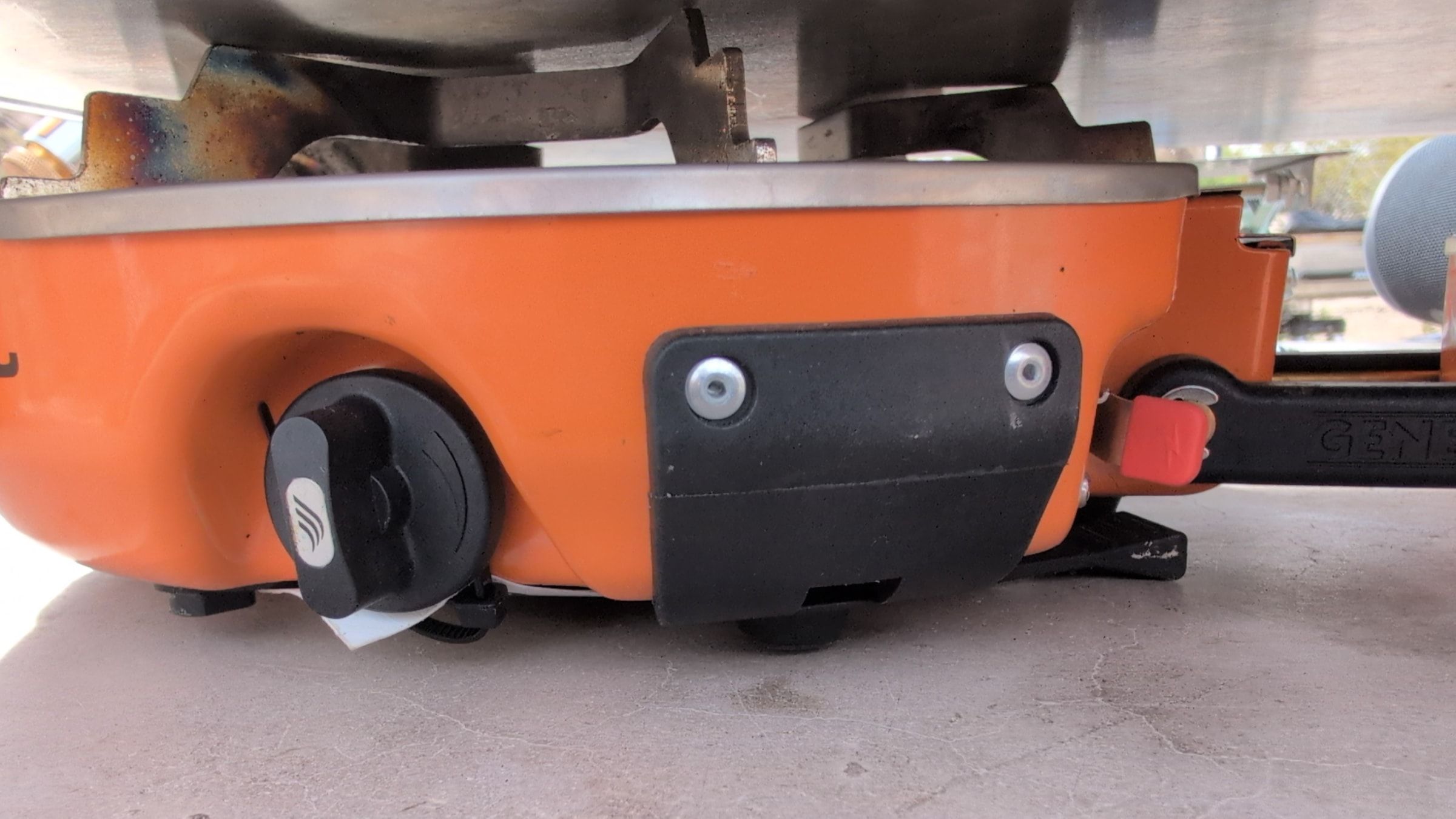 Close-up of burner control knob and red igniter lever