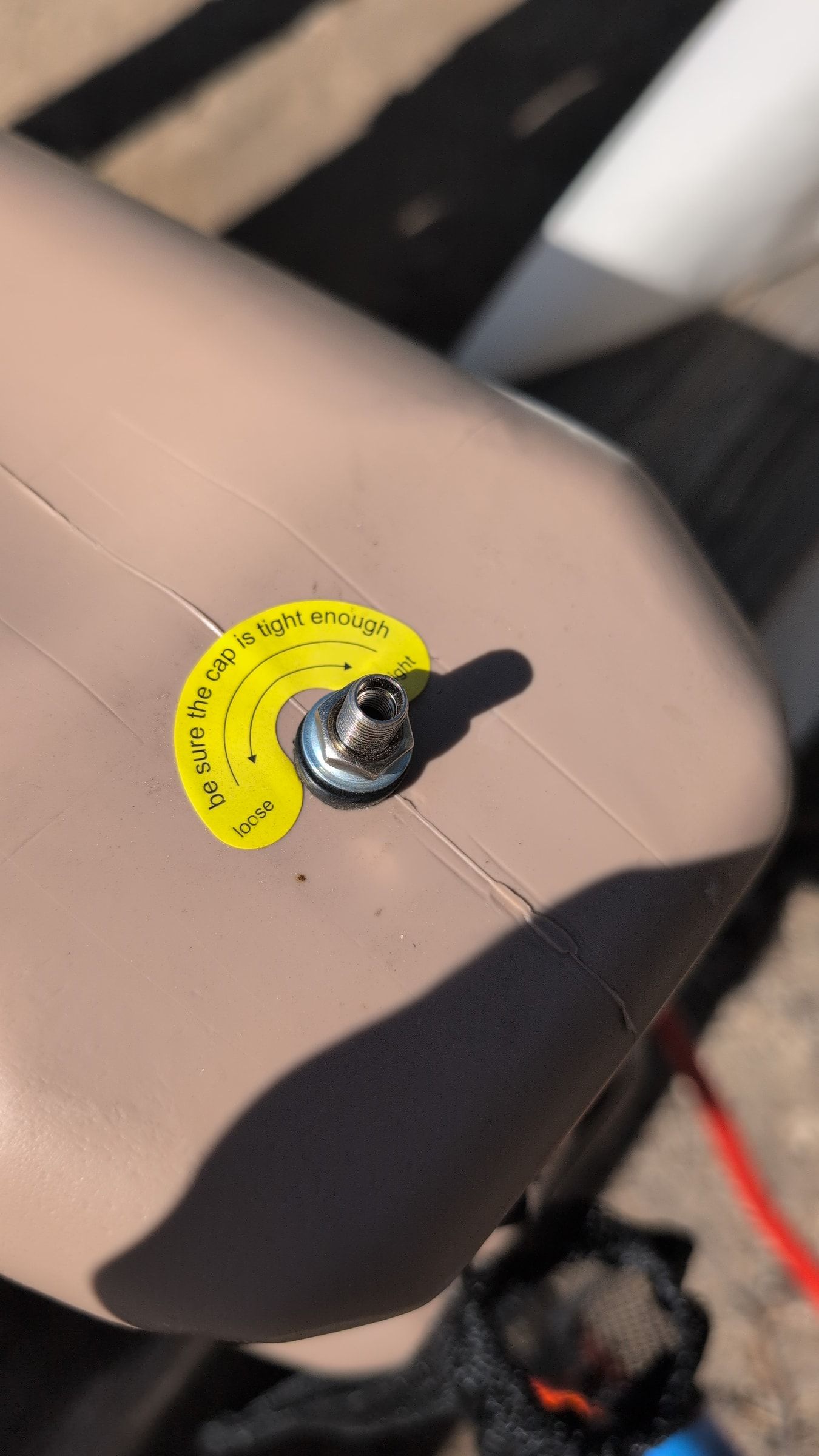 Close-up of air bleed valve on top of water jug being opened