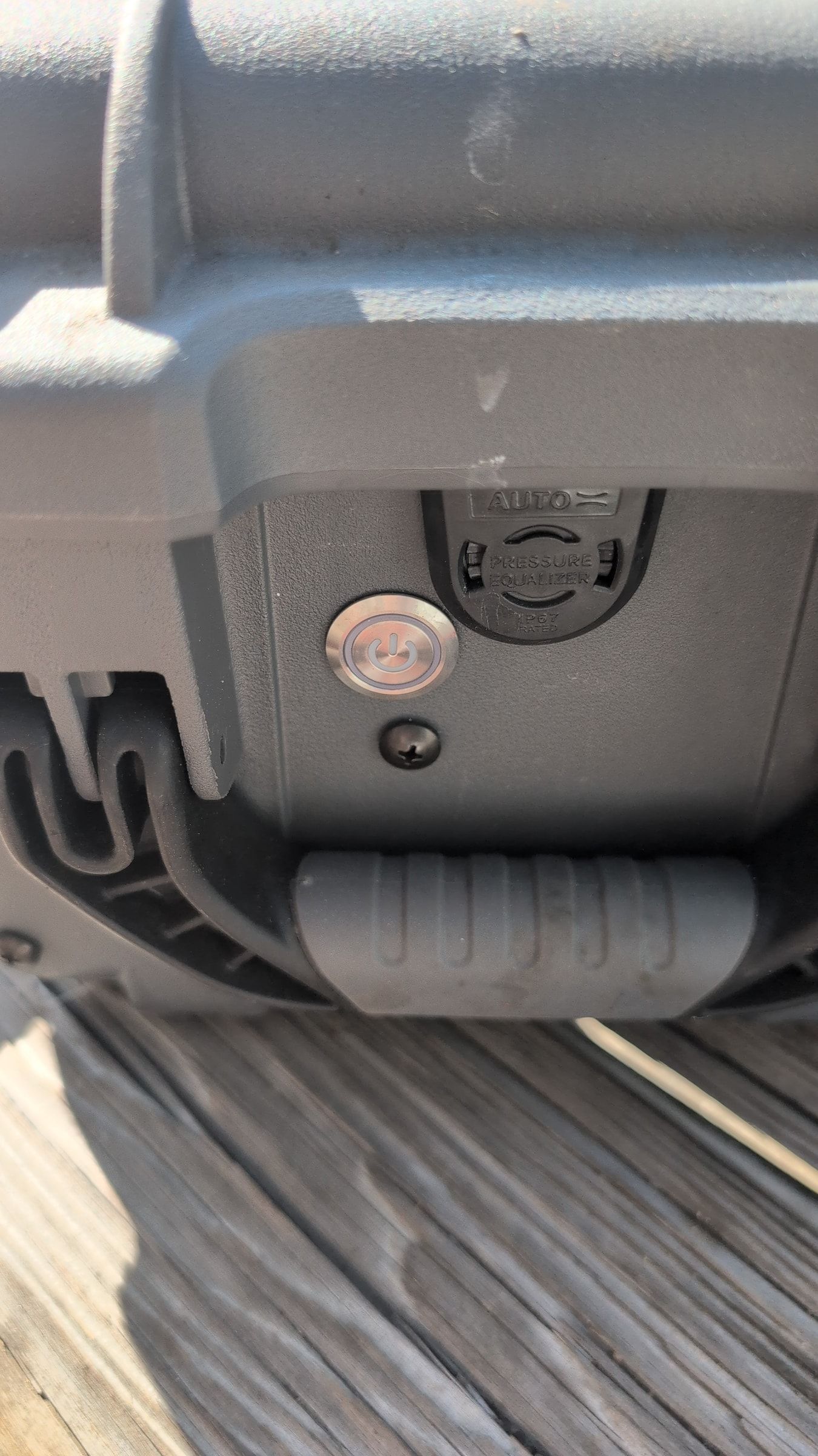Close-up of power button being pressed on Guzzle H2O unit