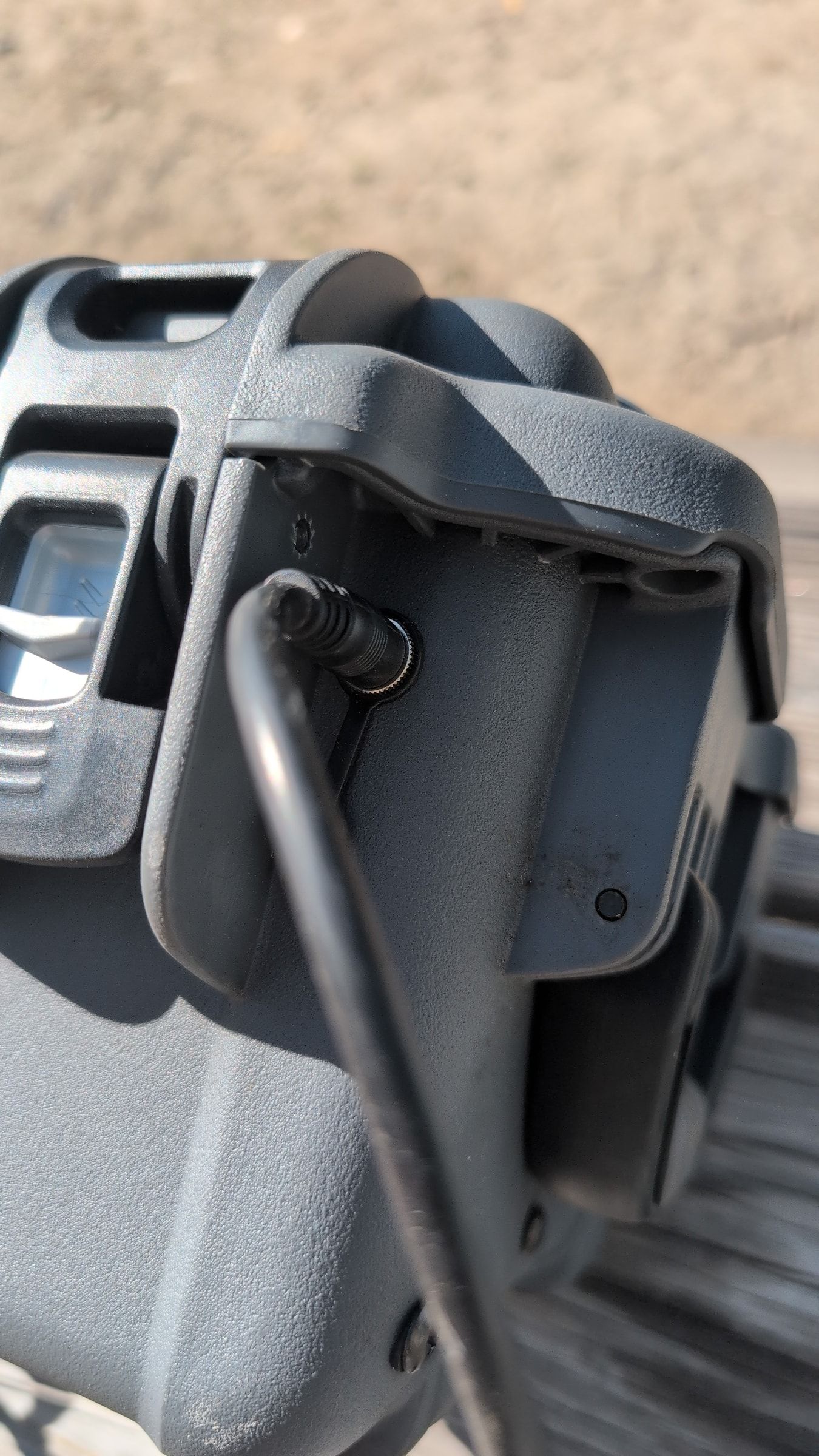 Close-up of power cord being plugged into Guzzle H2O power inlet port