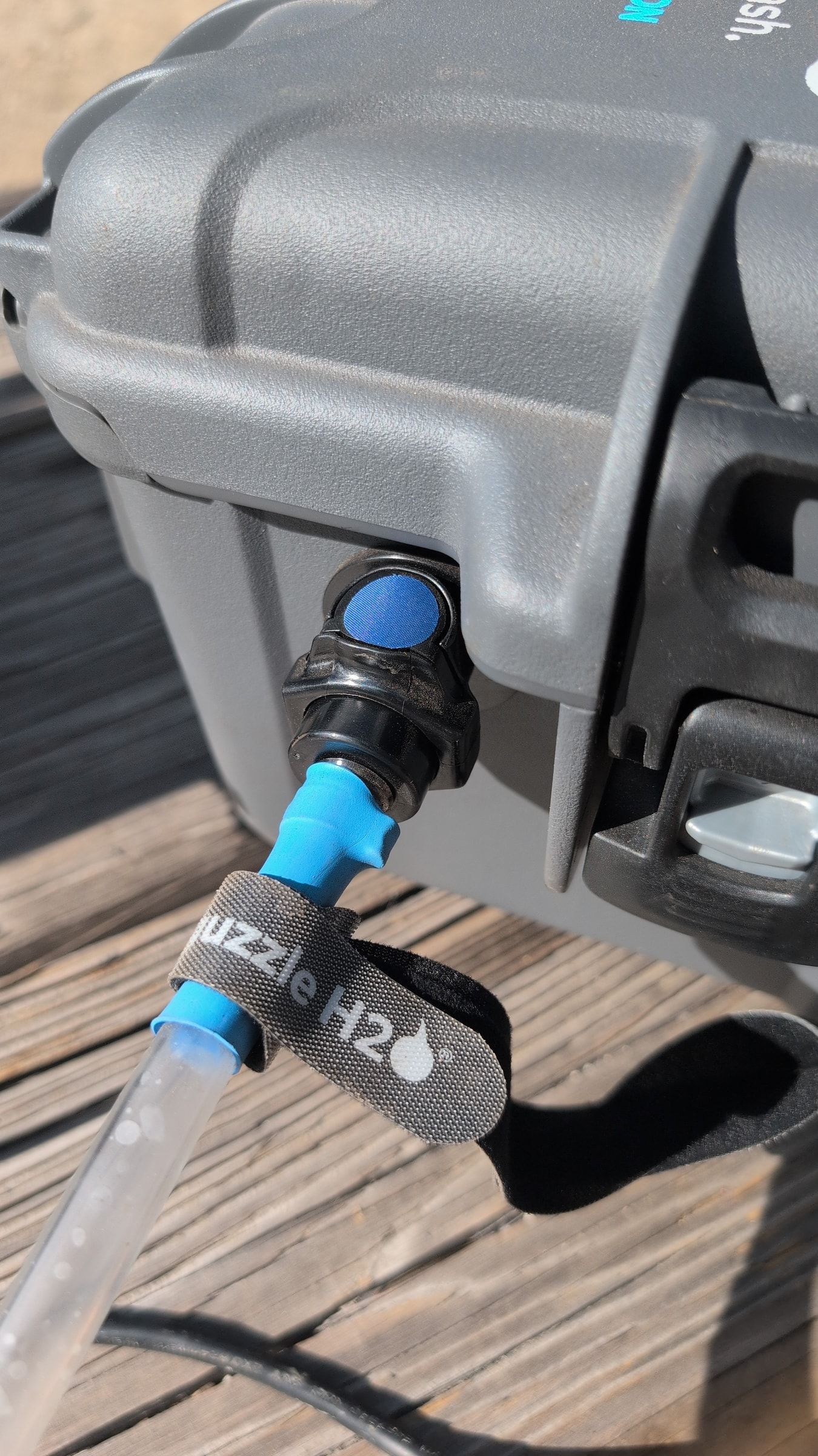 Photo of blue outlet hose connected to Guzzle H2O outlet fitting