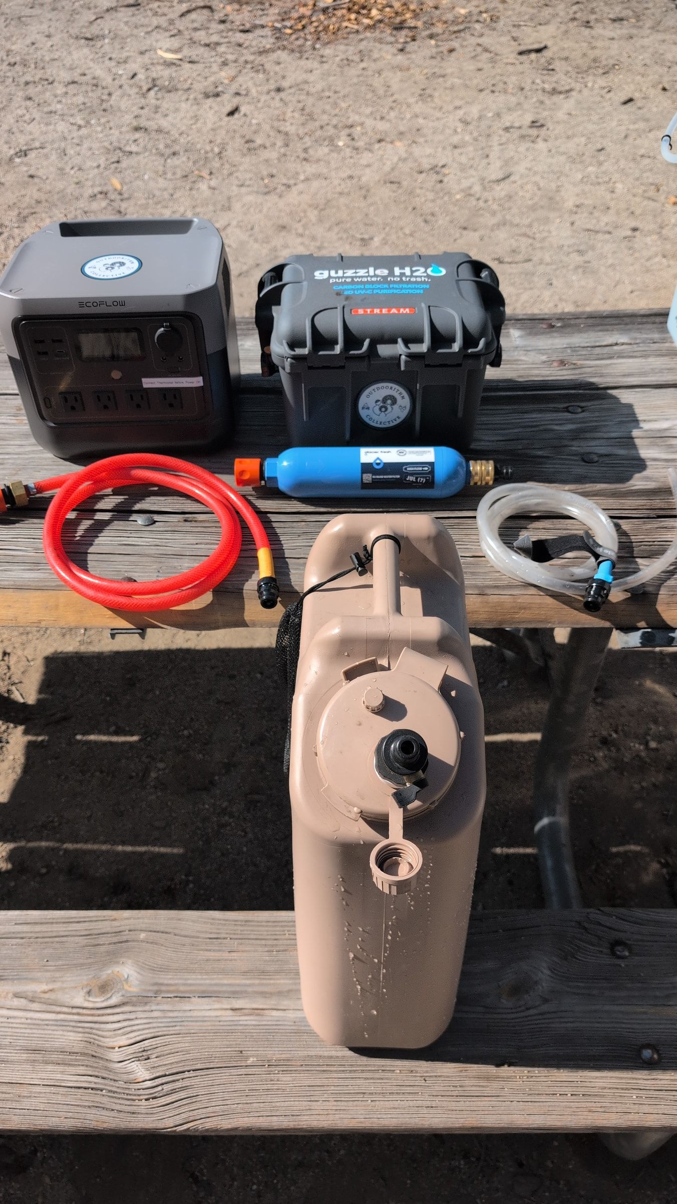 Photo of complete Guzzle H2O water filtration system laid out at campsite