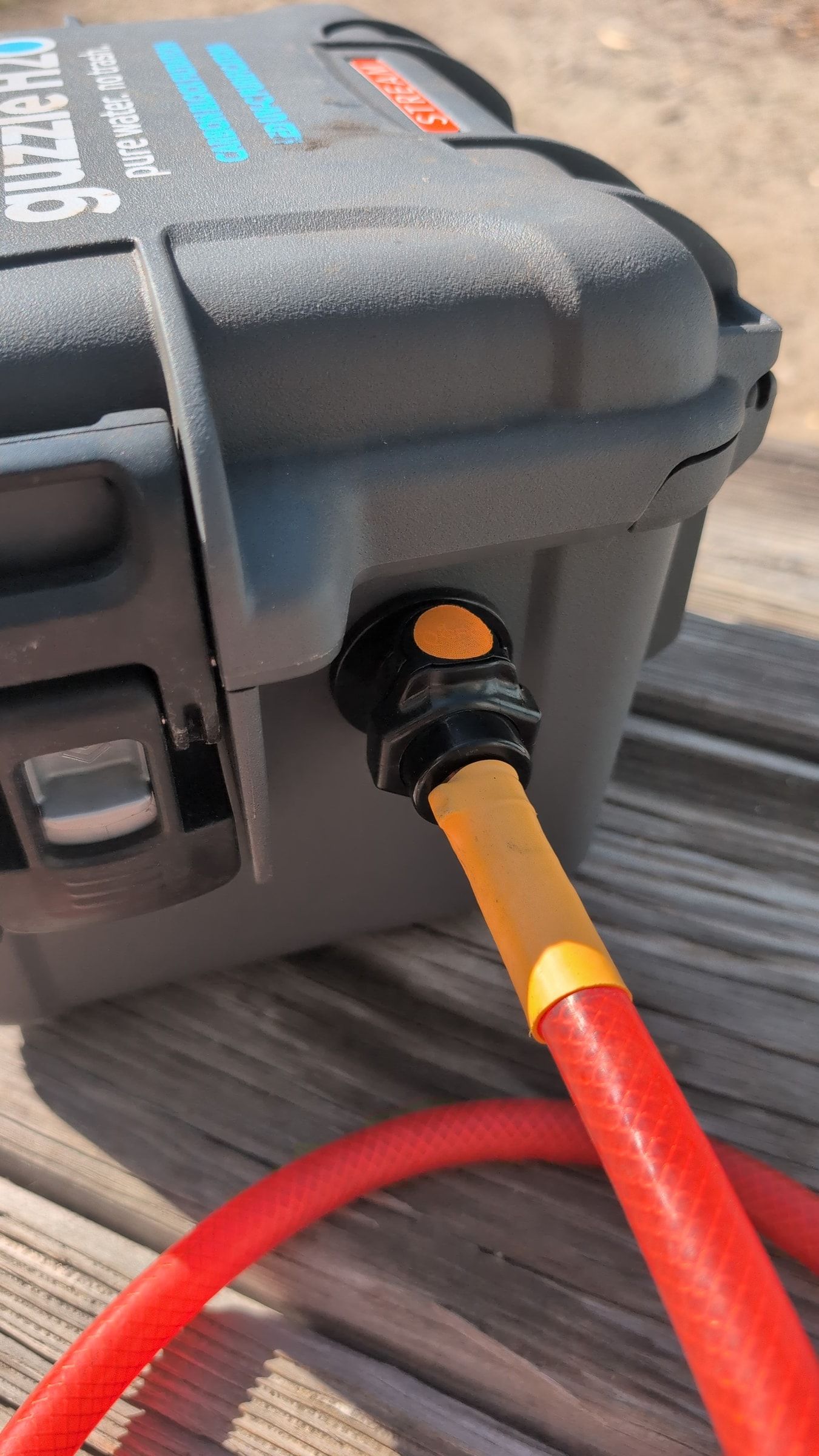Photo of red inlet hose connected to Guzzle H2O inlet fitting