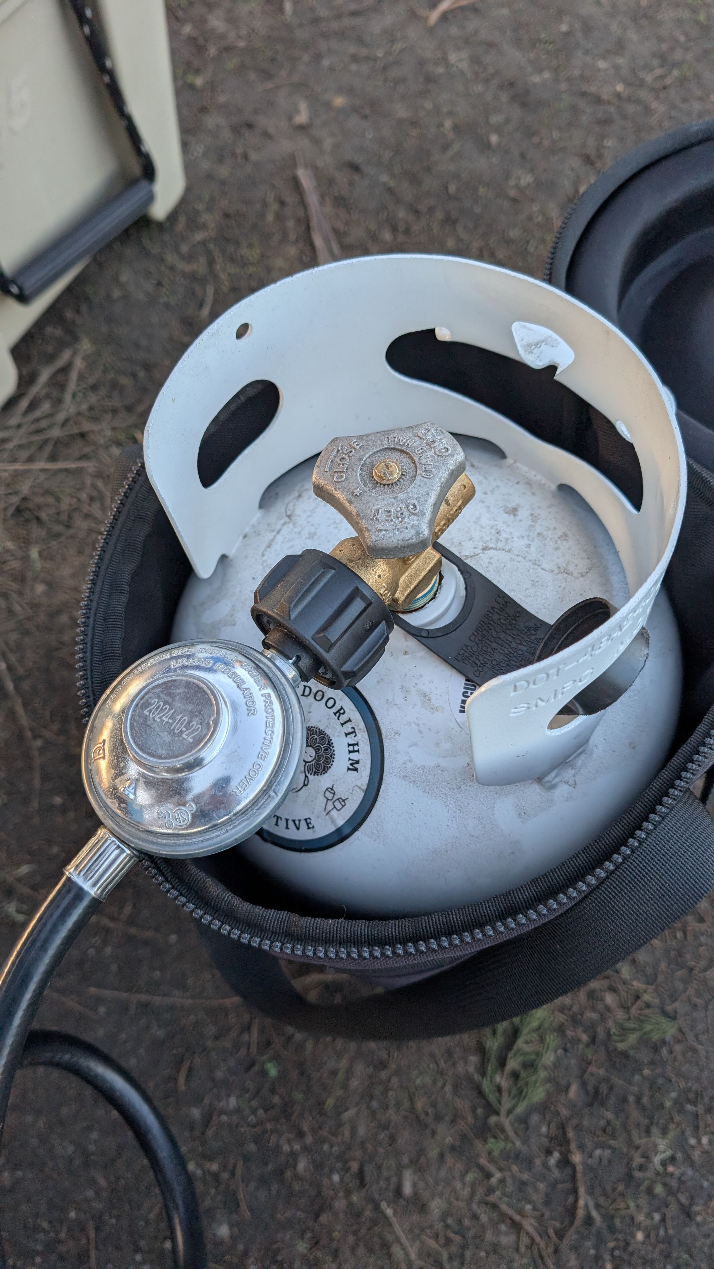 Photo of propane tank with regulator and gas line connected