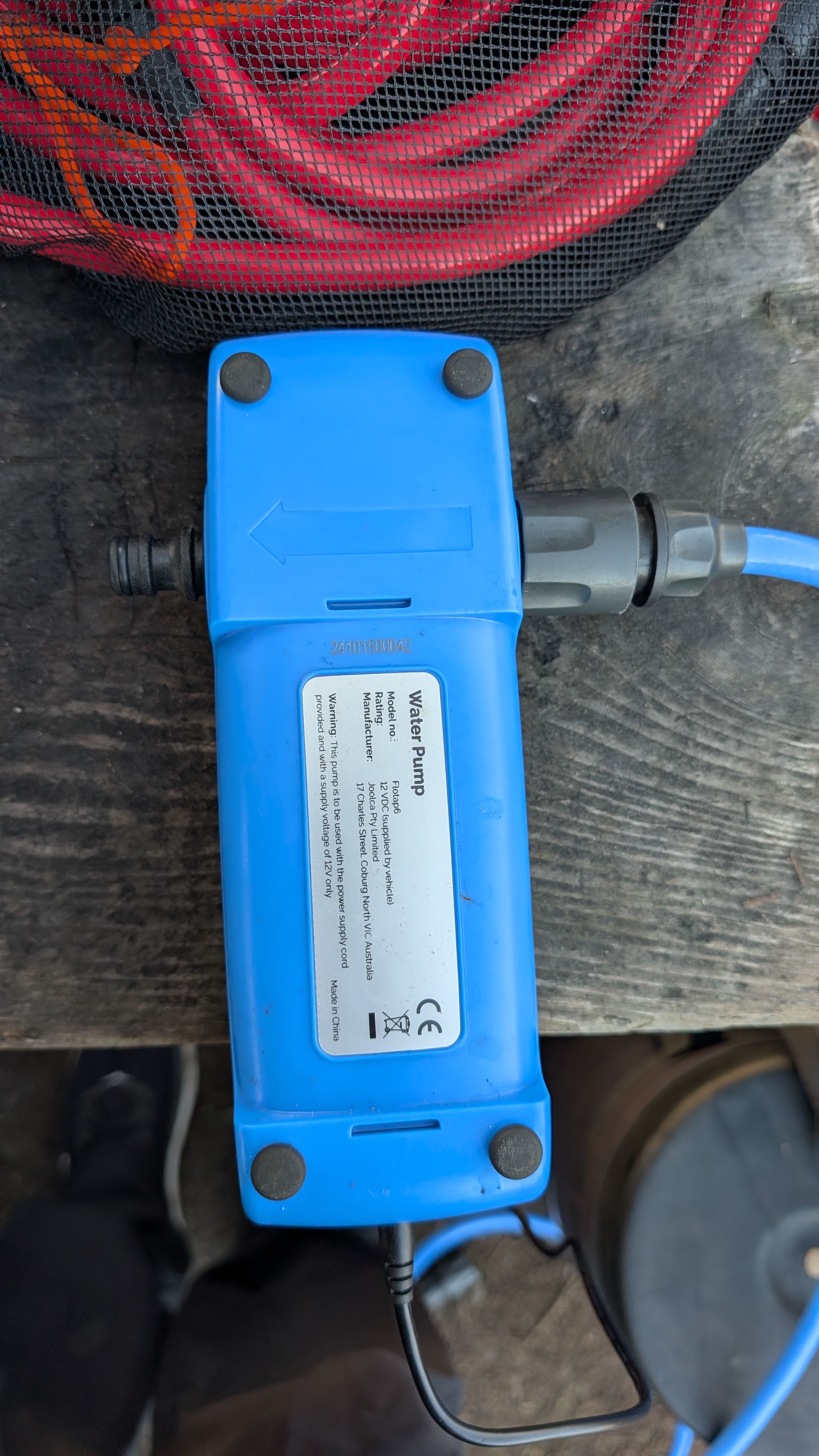 Photo of pump bottom showing directional arrow for water flow