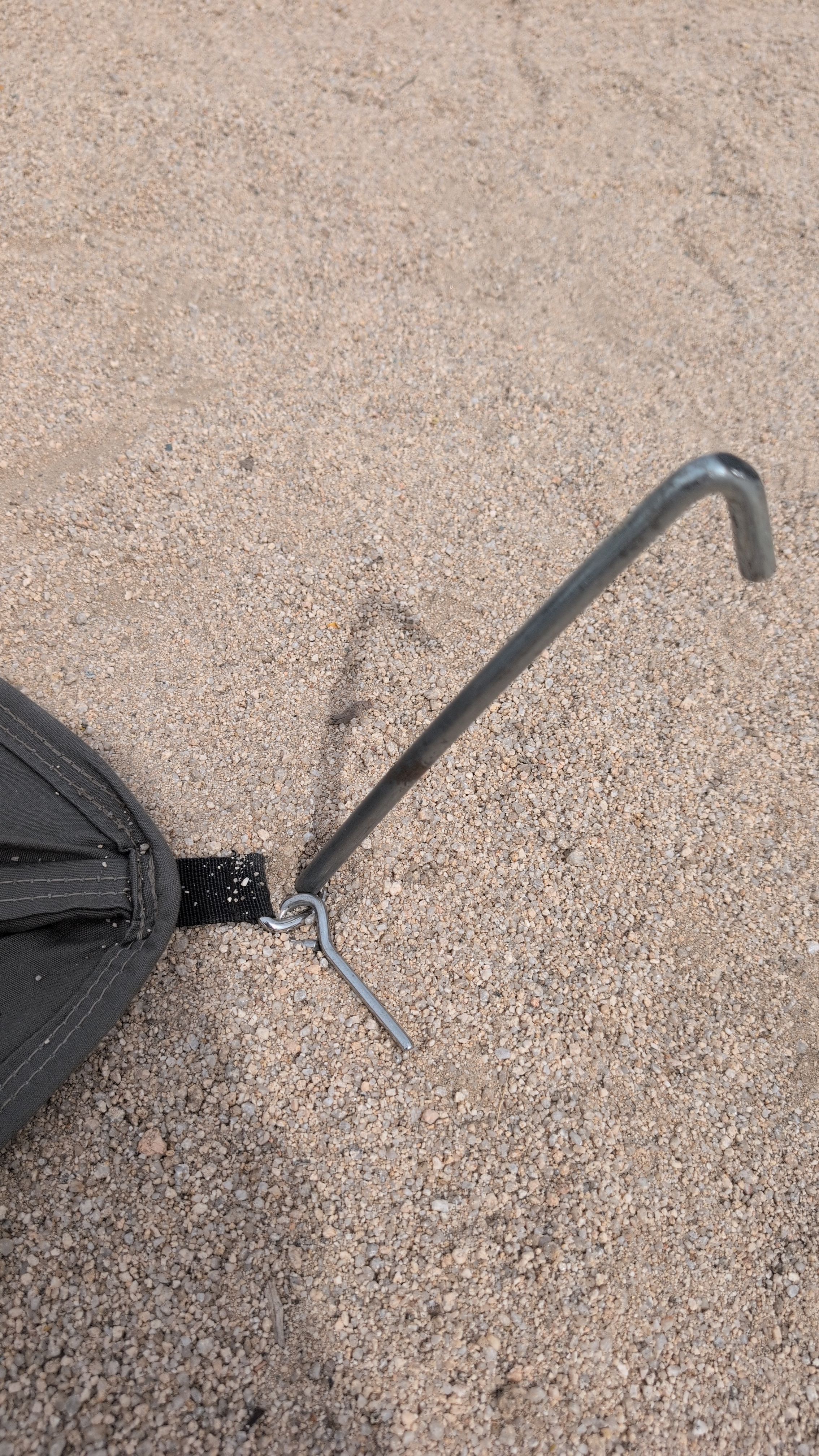 Photo of corner stake driven at 45 degrees angled away from the tent body