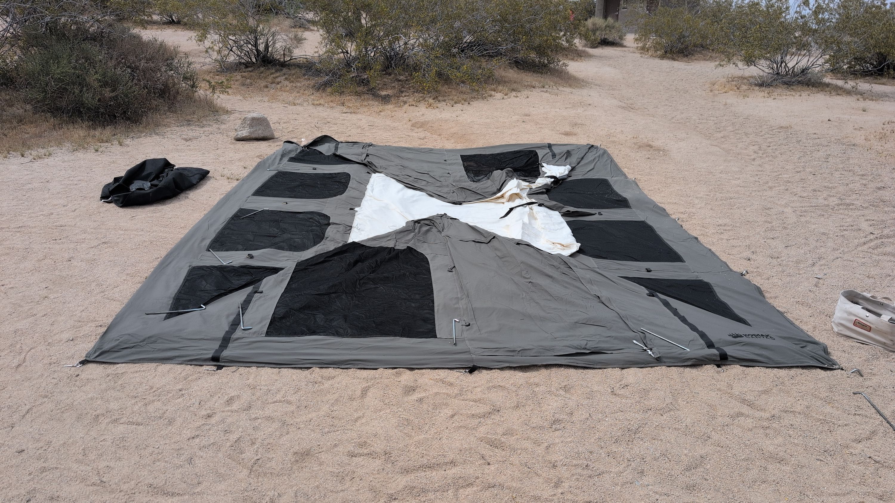 Photo of Kodiak Cabin tent body laid flat on top of ground sheet with corners lined up