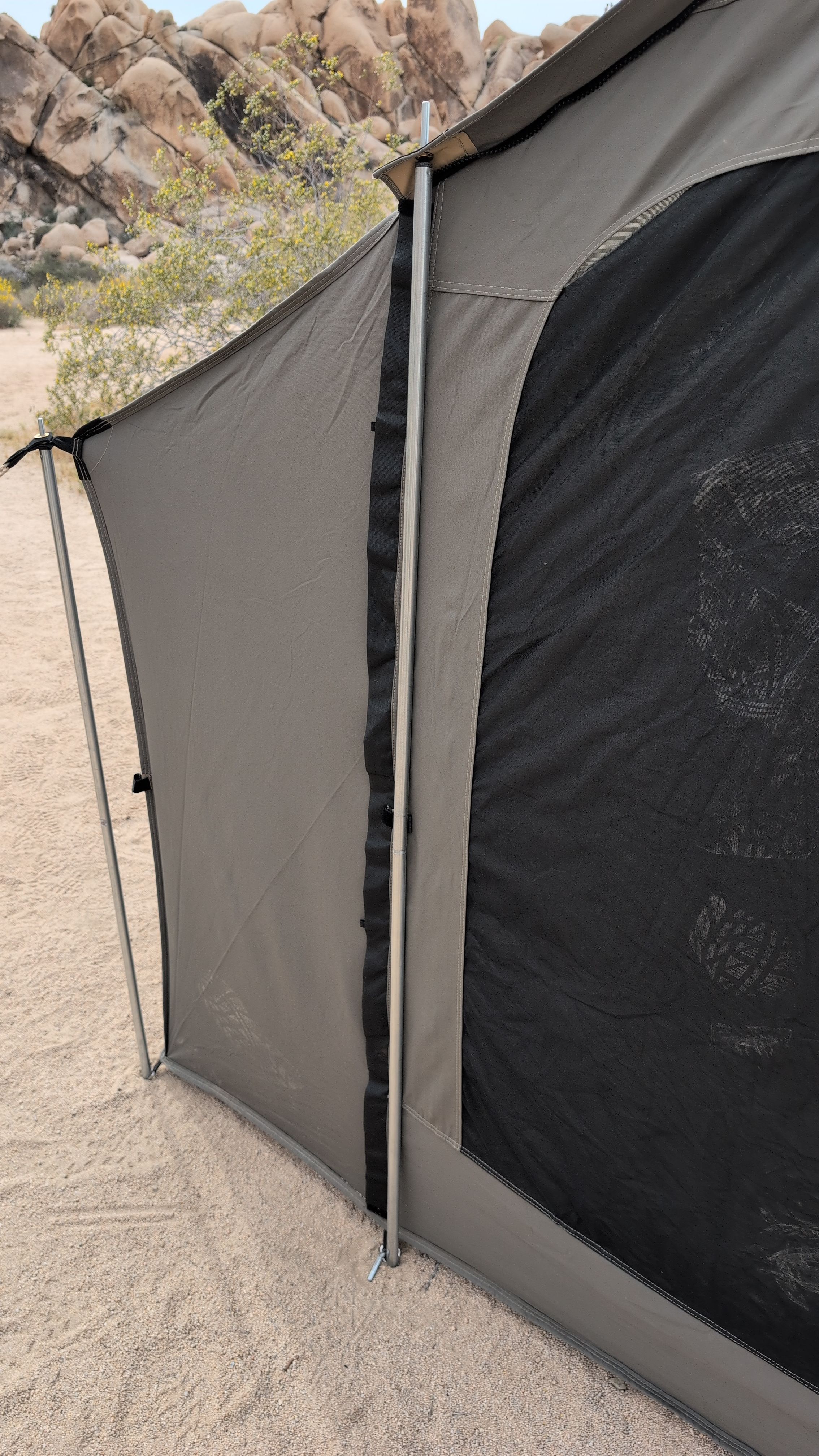 Photo of taller door-frame pole installed beside a door with guy line staked out