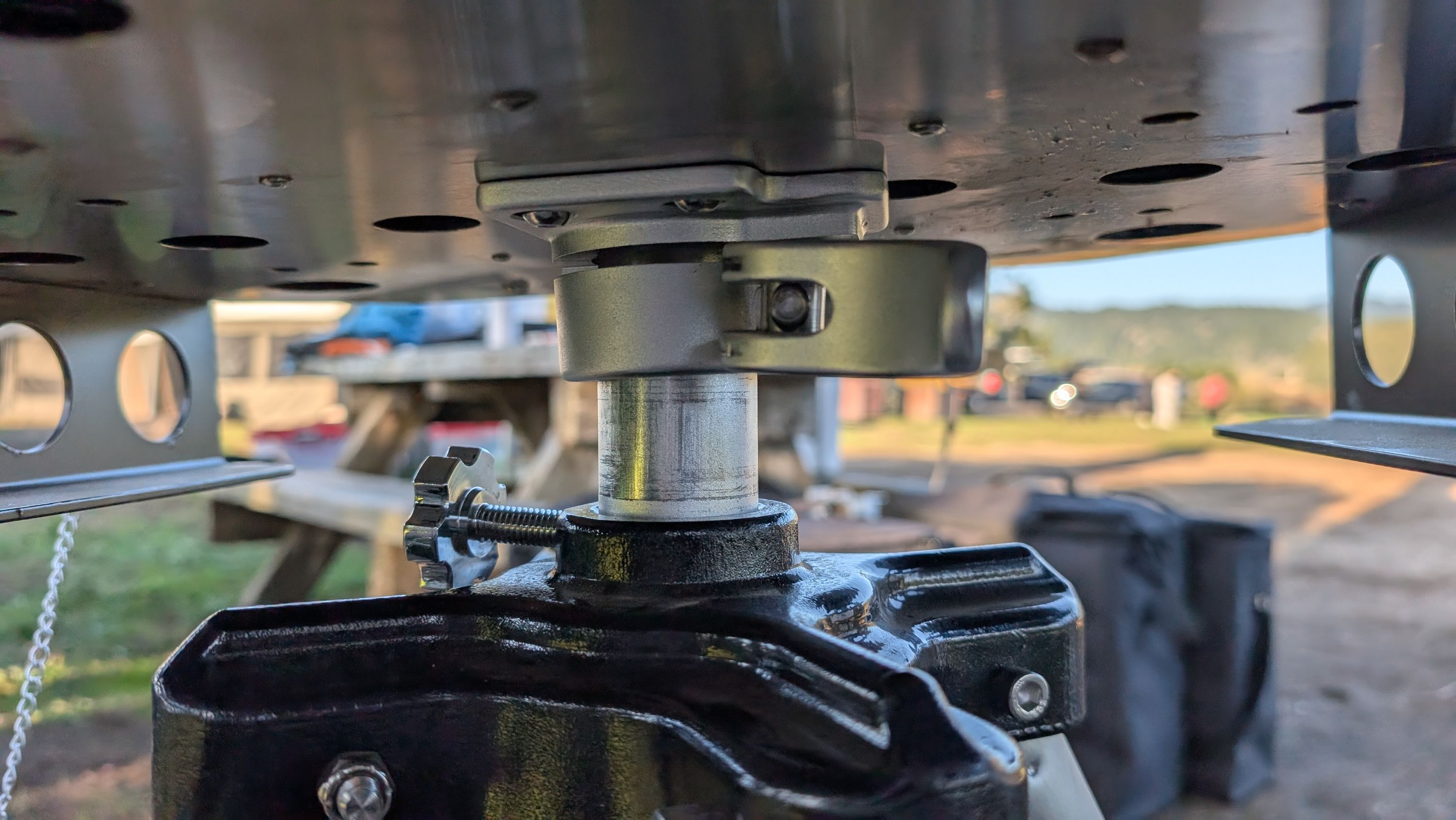 Close-up of grill mounting clamp underneath the firebox on the tripod tube
