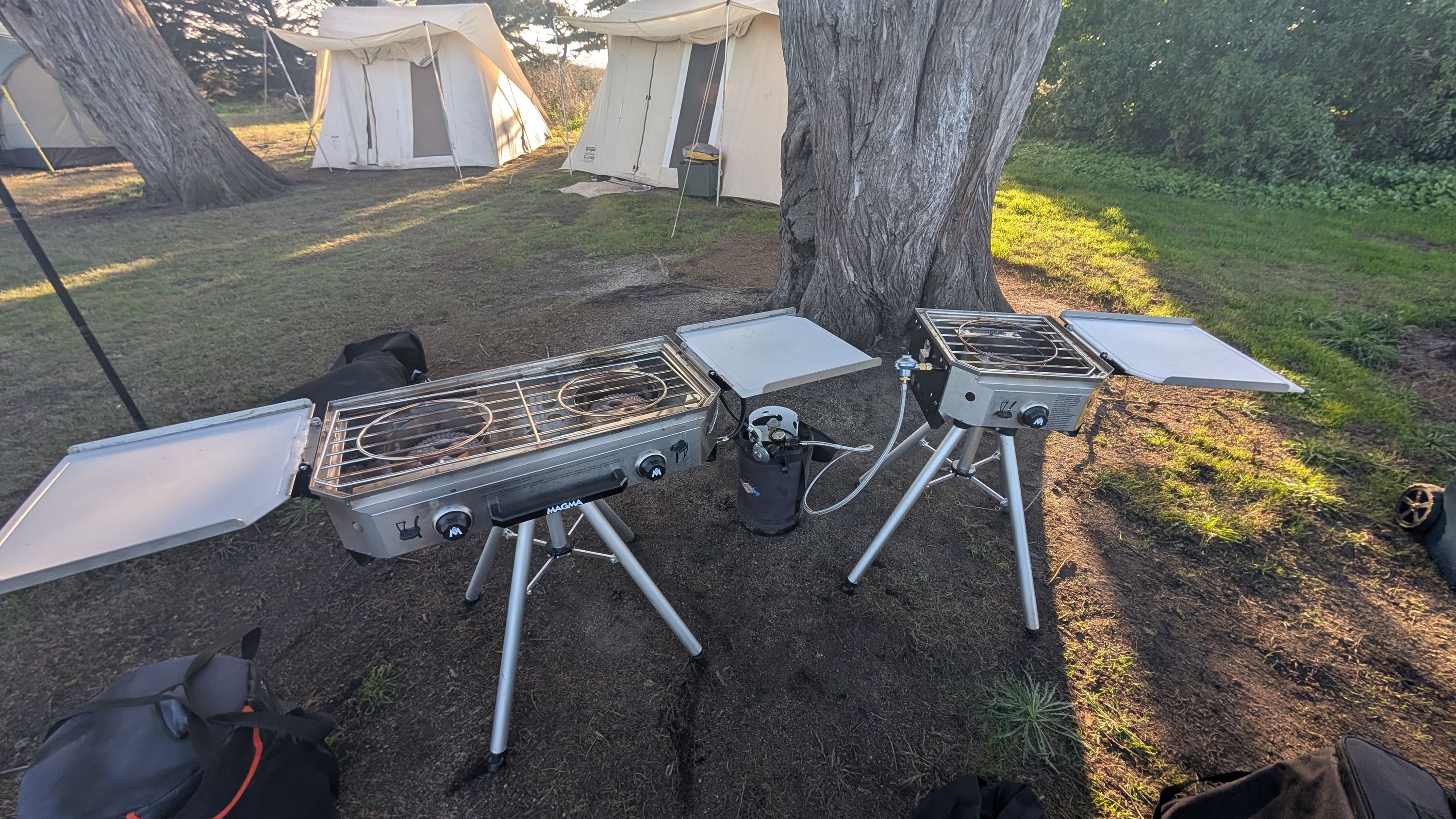 Photo of both Magma Crossover grills fully assembled with lids open and cutting boards deployed