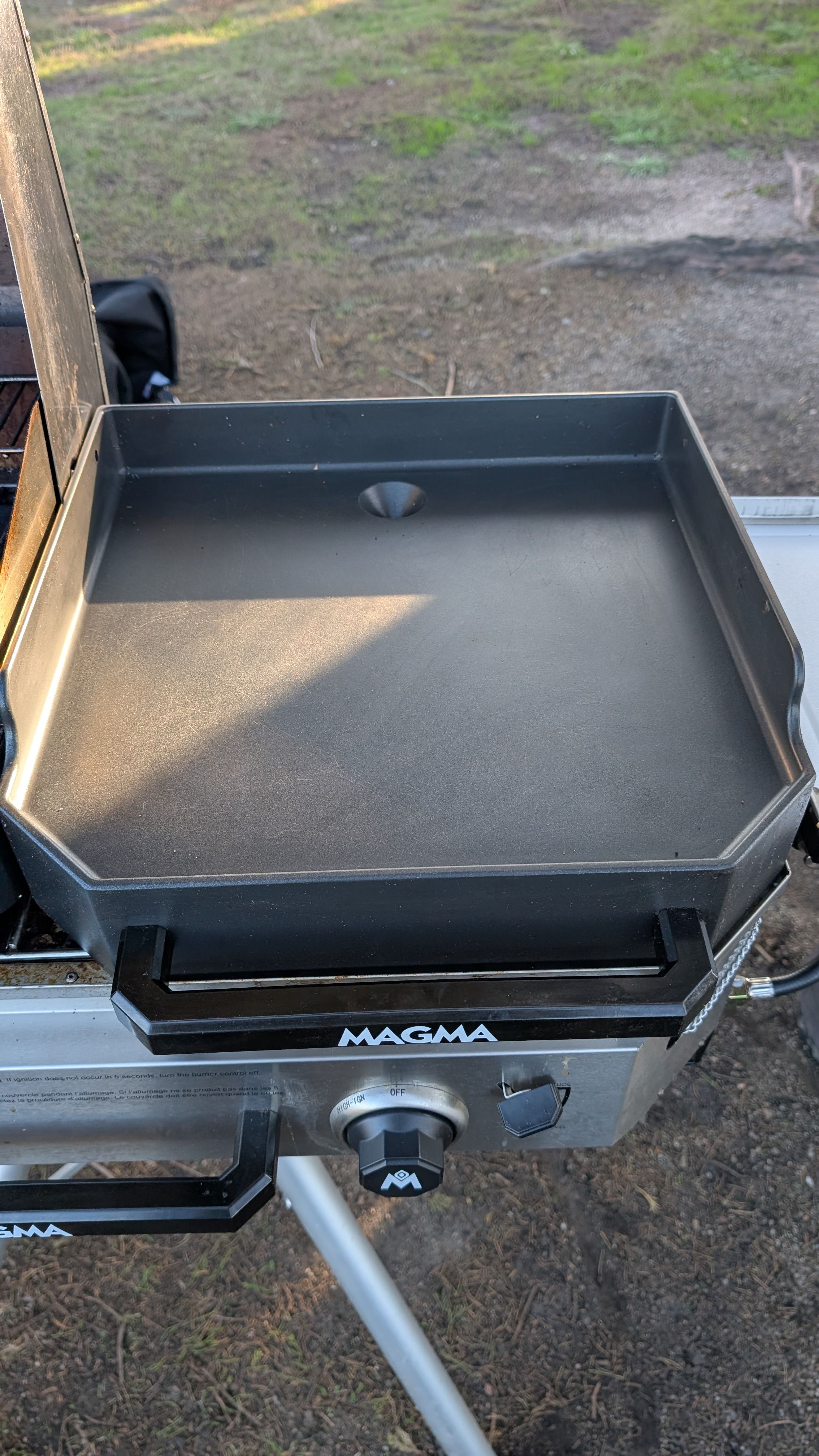 Photo of flat griddle attachment sitting on single burner firebox