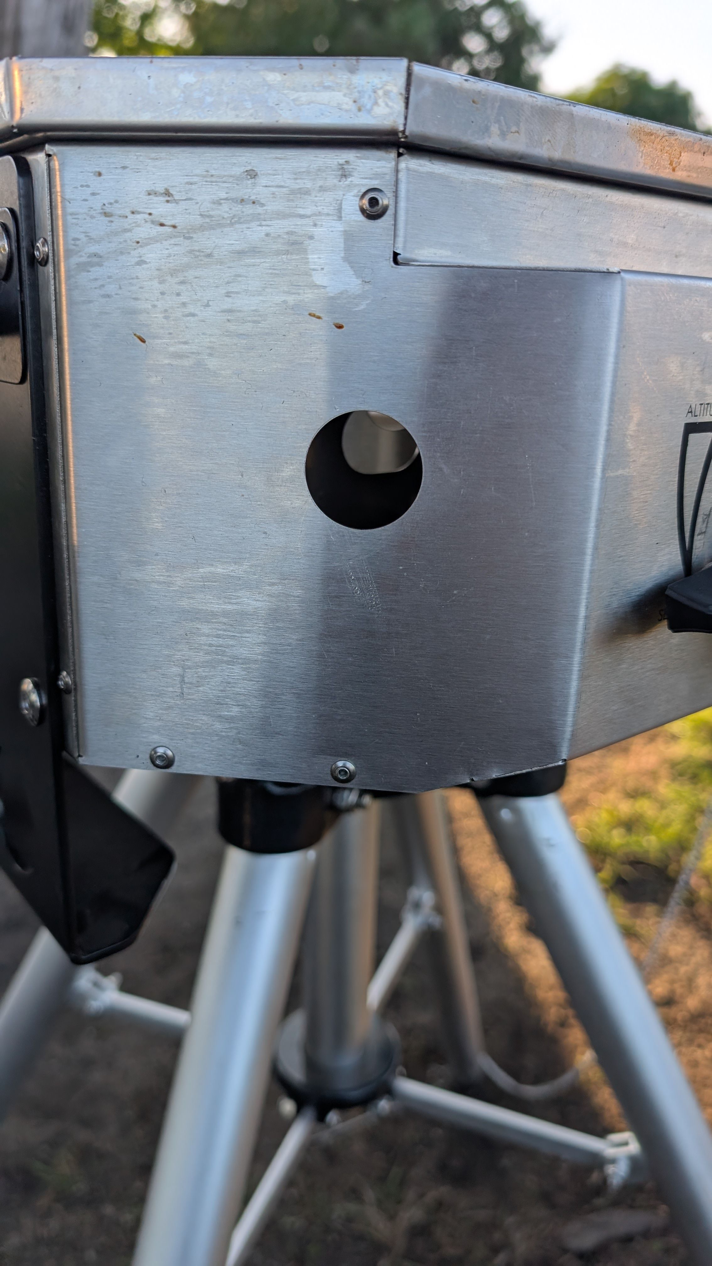 Photo of lighter access hole on the side of the grill firebox