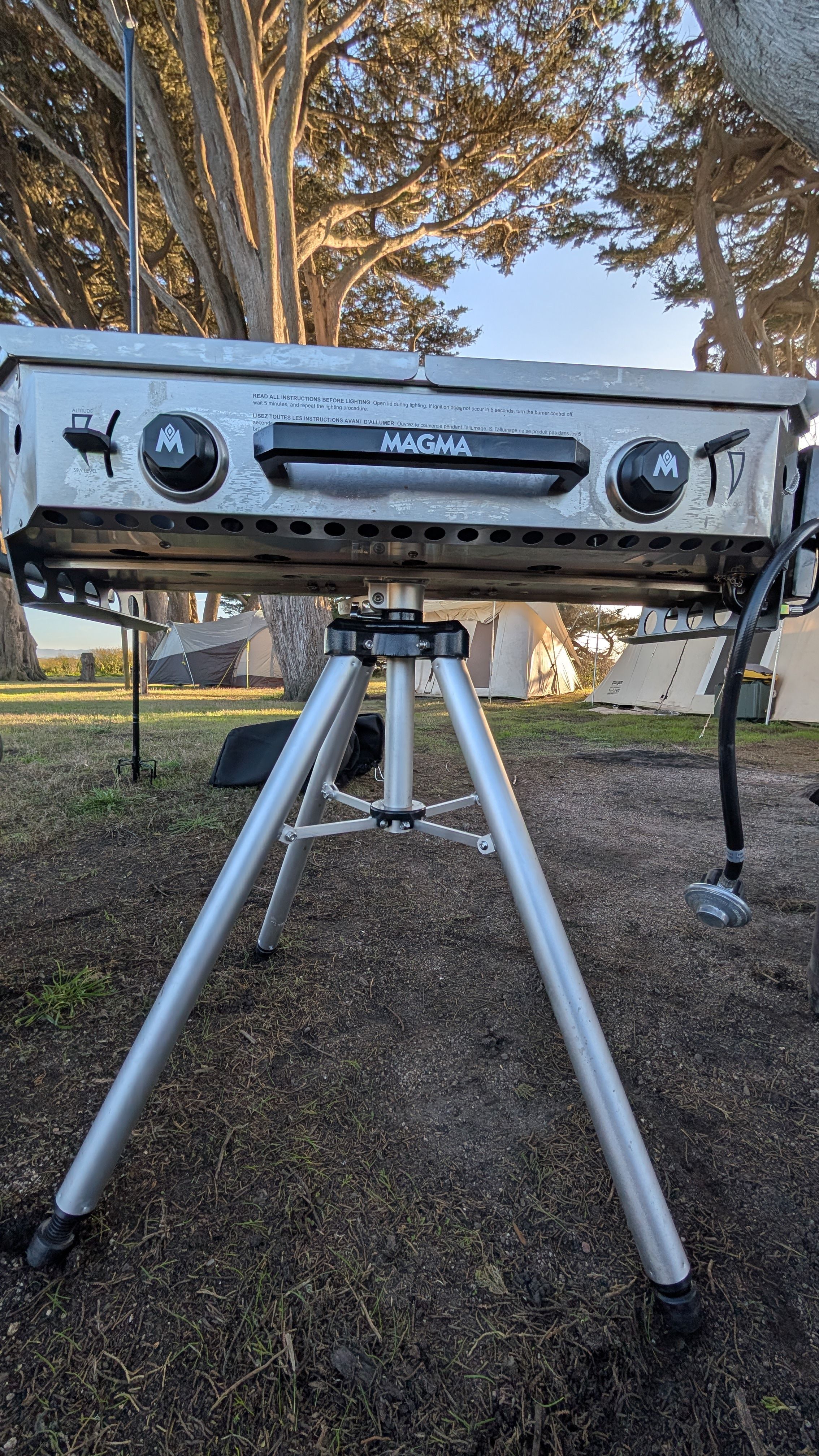 Photo of Magma Crossover double burner firebox on tripod showing dual control knobs
