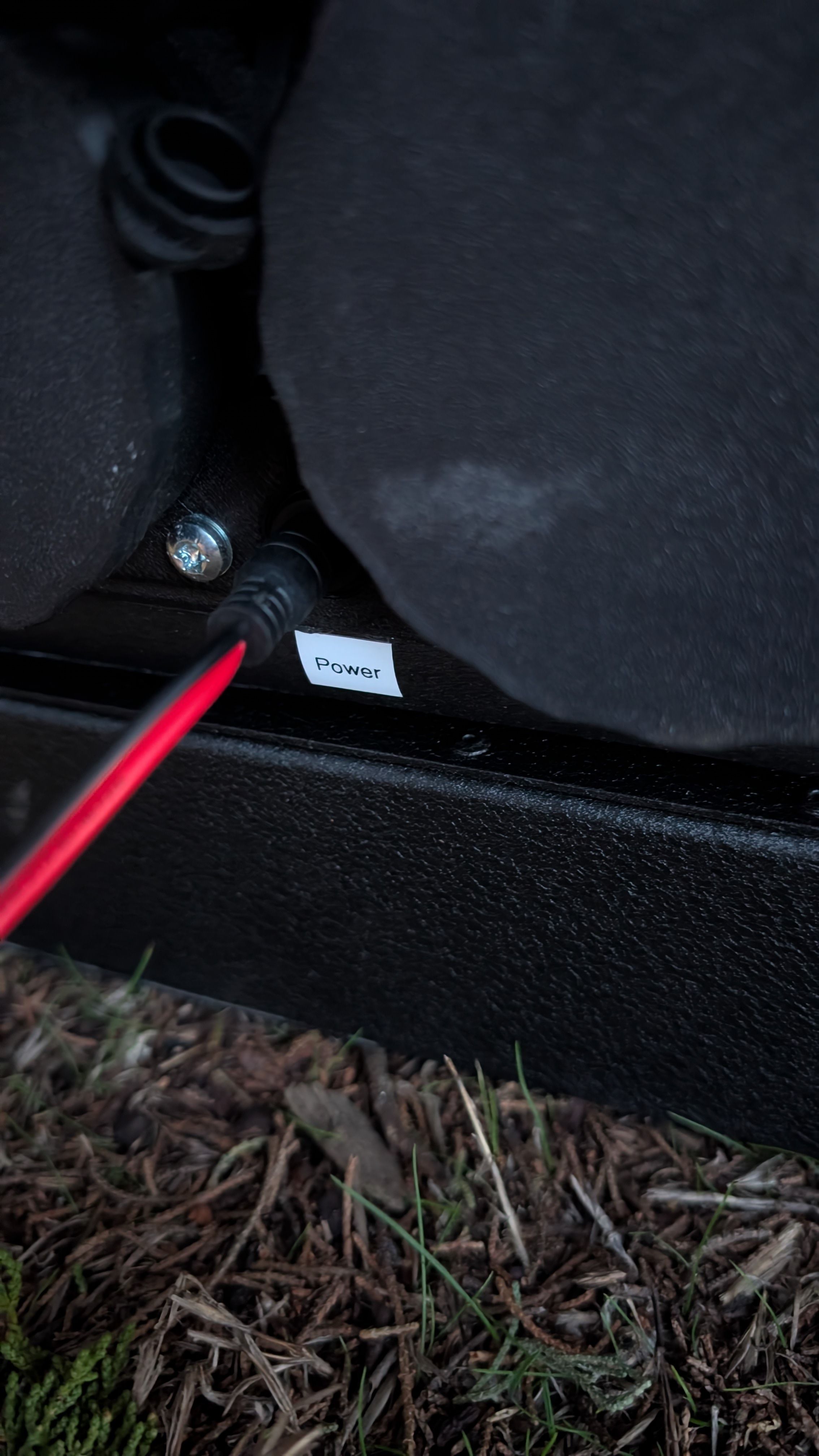 Close-up of 12V power cable being unplugged from heater