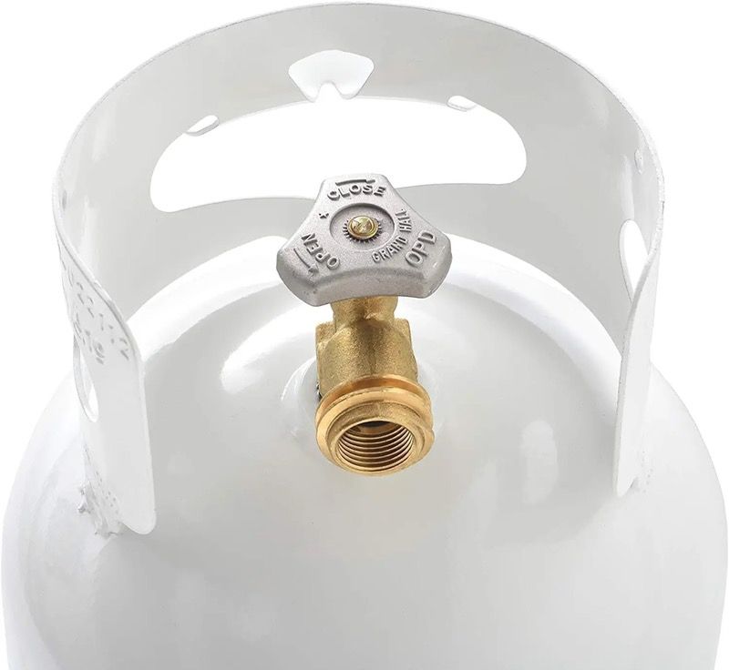 Close-up of propane tank valve being turned clockwise to close