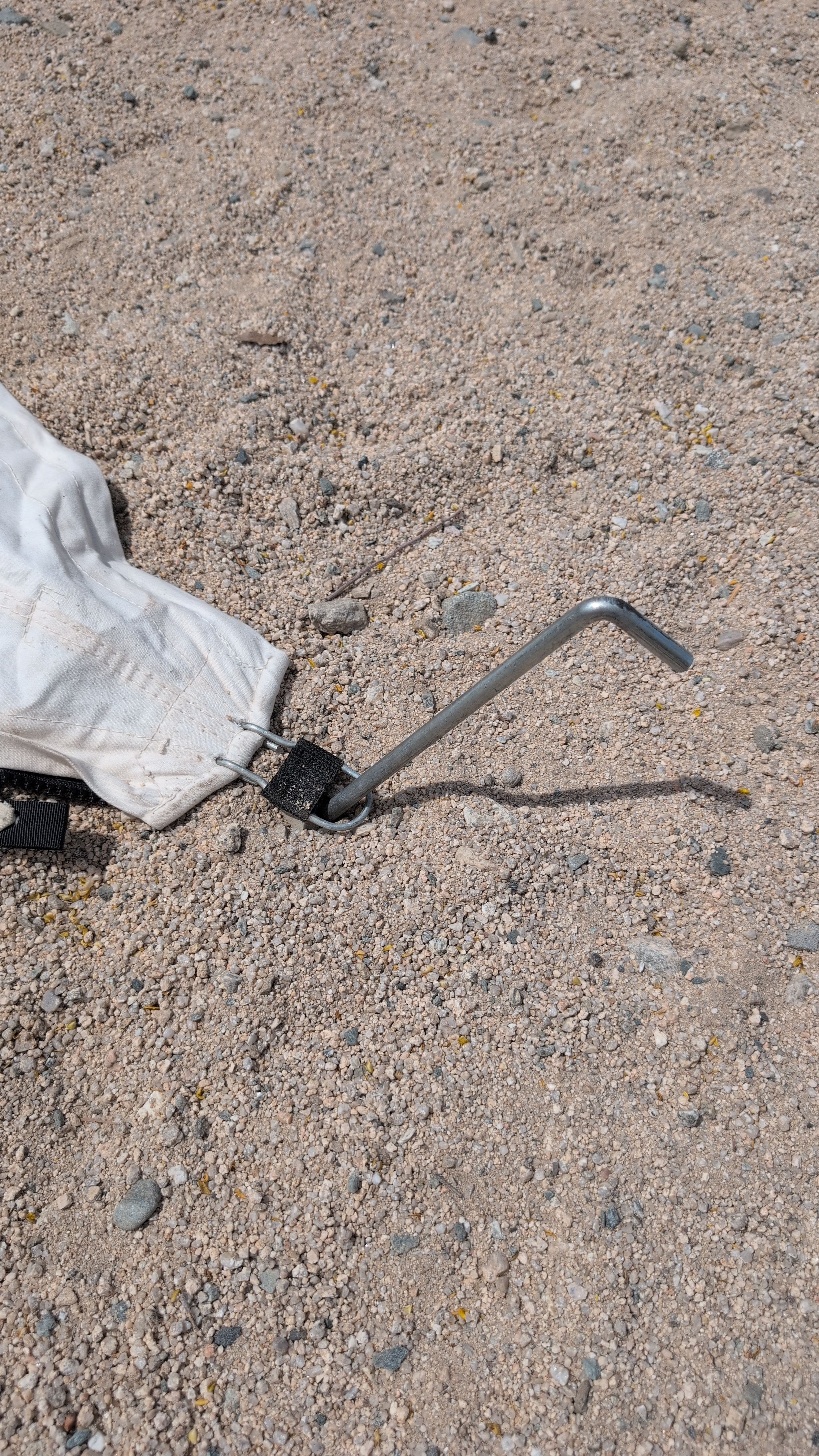 Close-up of corner stake driven through ground hook