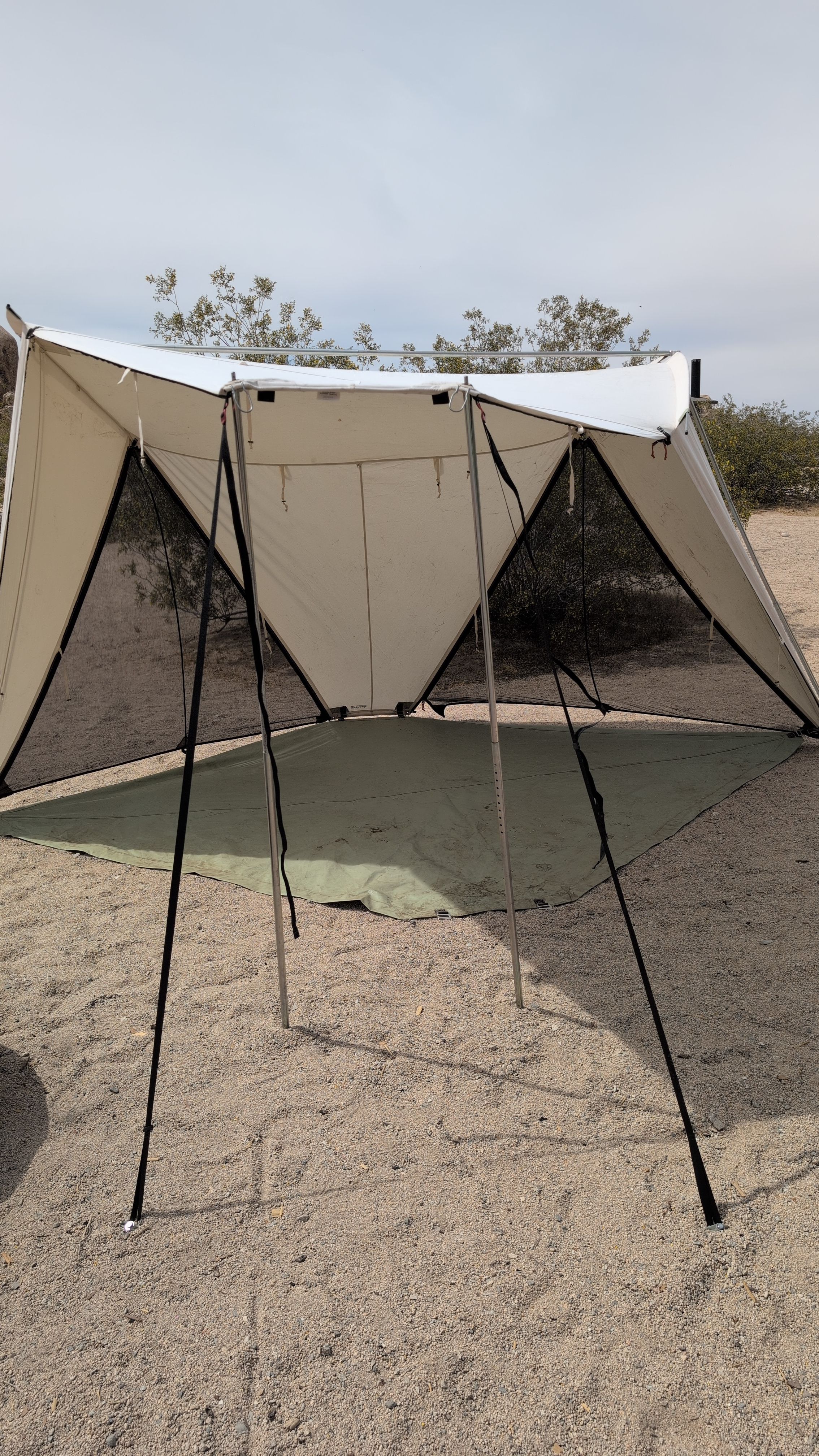 Photo of awning extended with guy lines staked