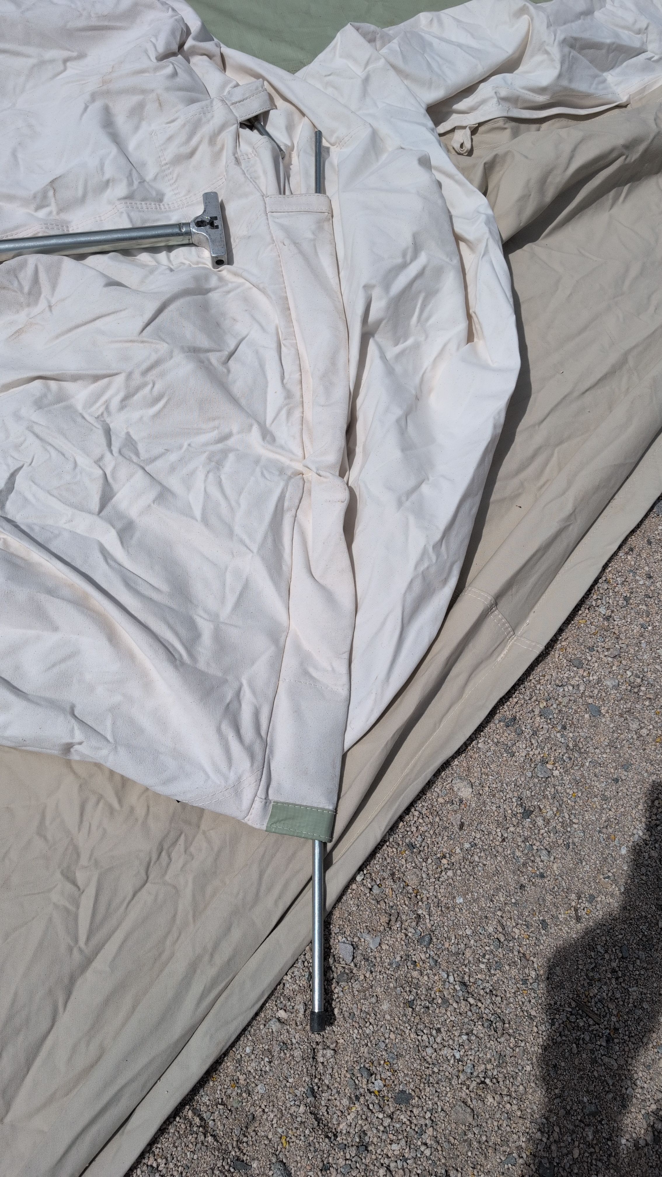 Photo of crossbar pole being threaded through roof sleeve