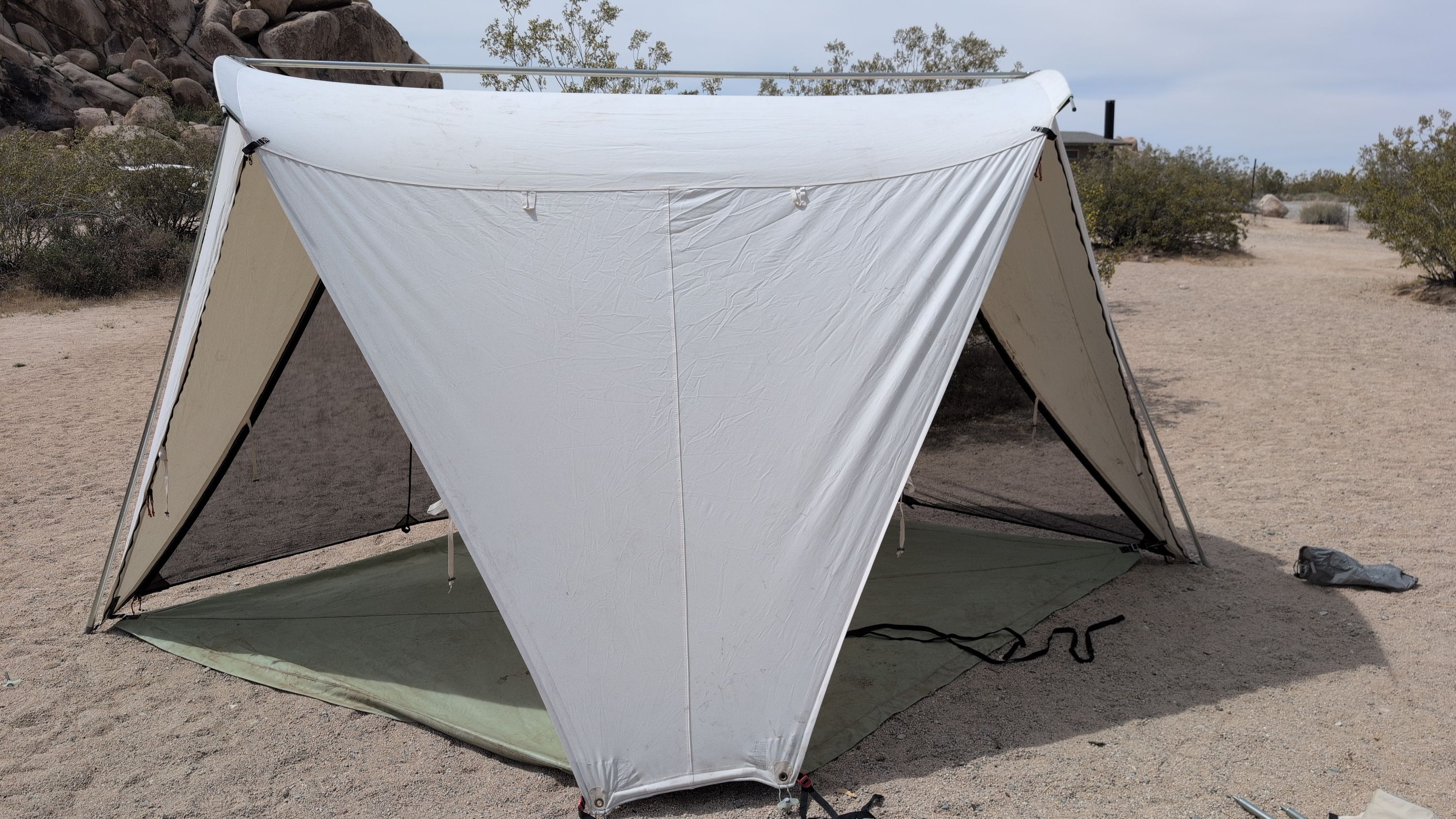 Photo of shelter with two open sides and two mesh side panels installed