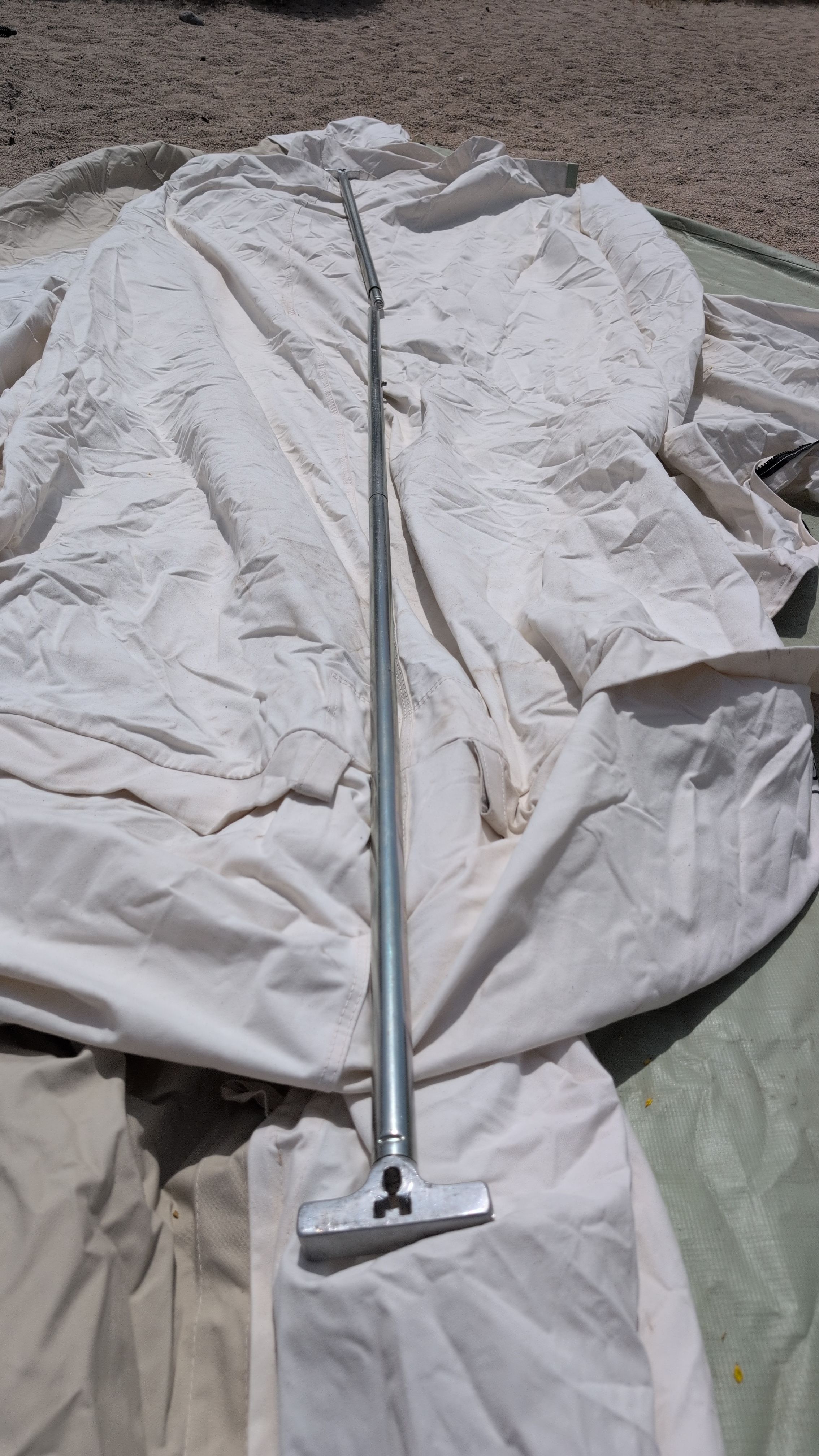 Photo of T-connector poles laid out alongside the shelter