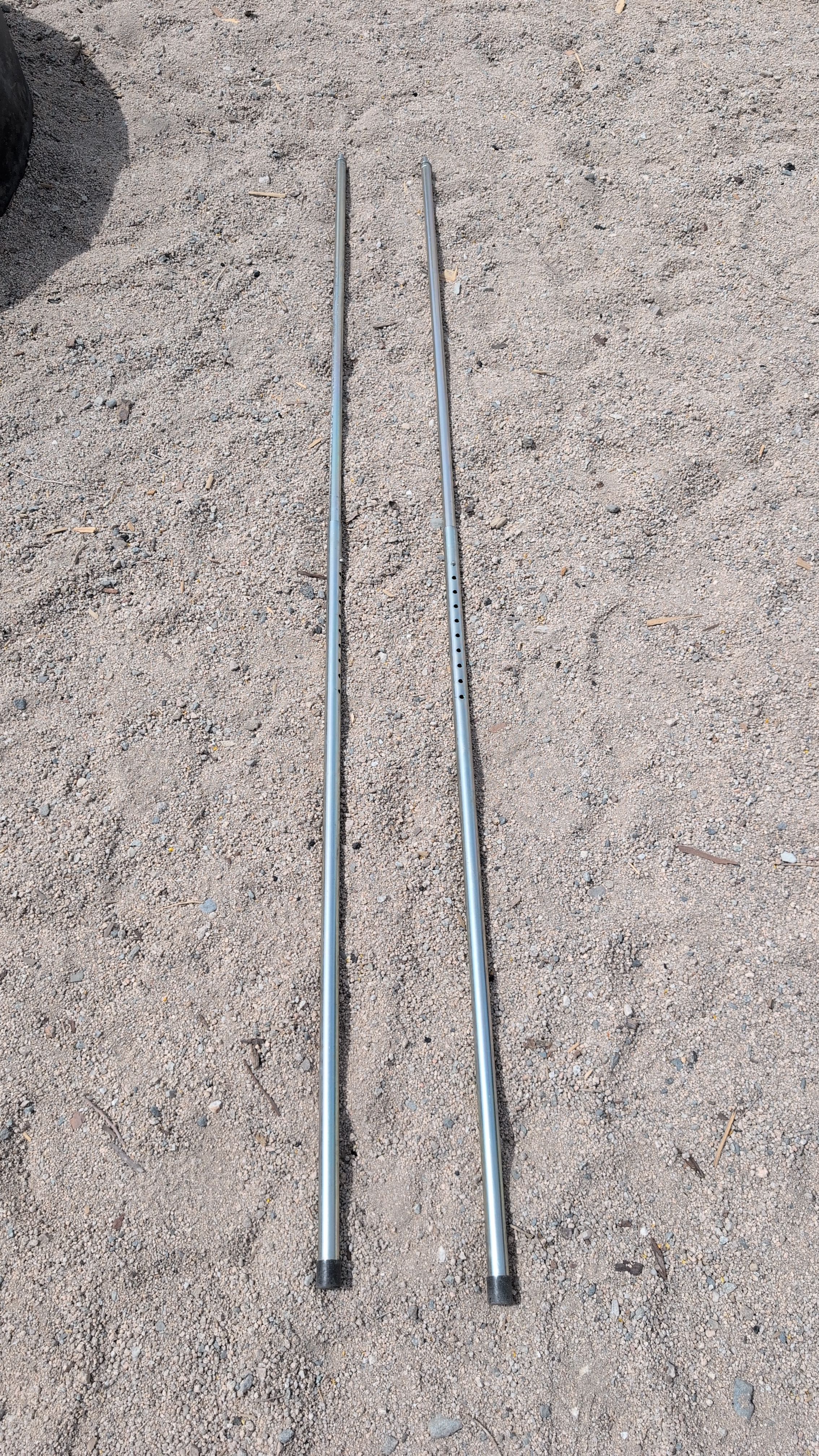 Photo of the two awning support poles ready to lift up one side of the shelter