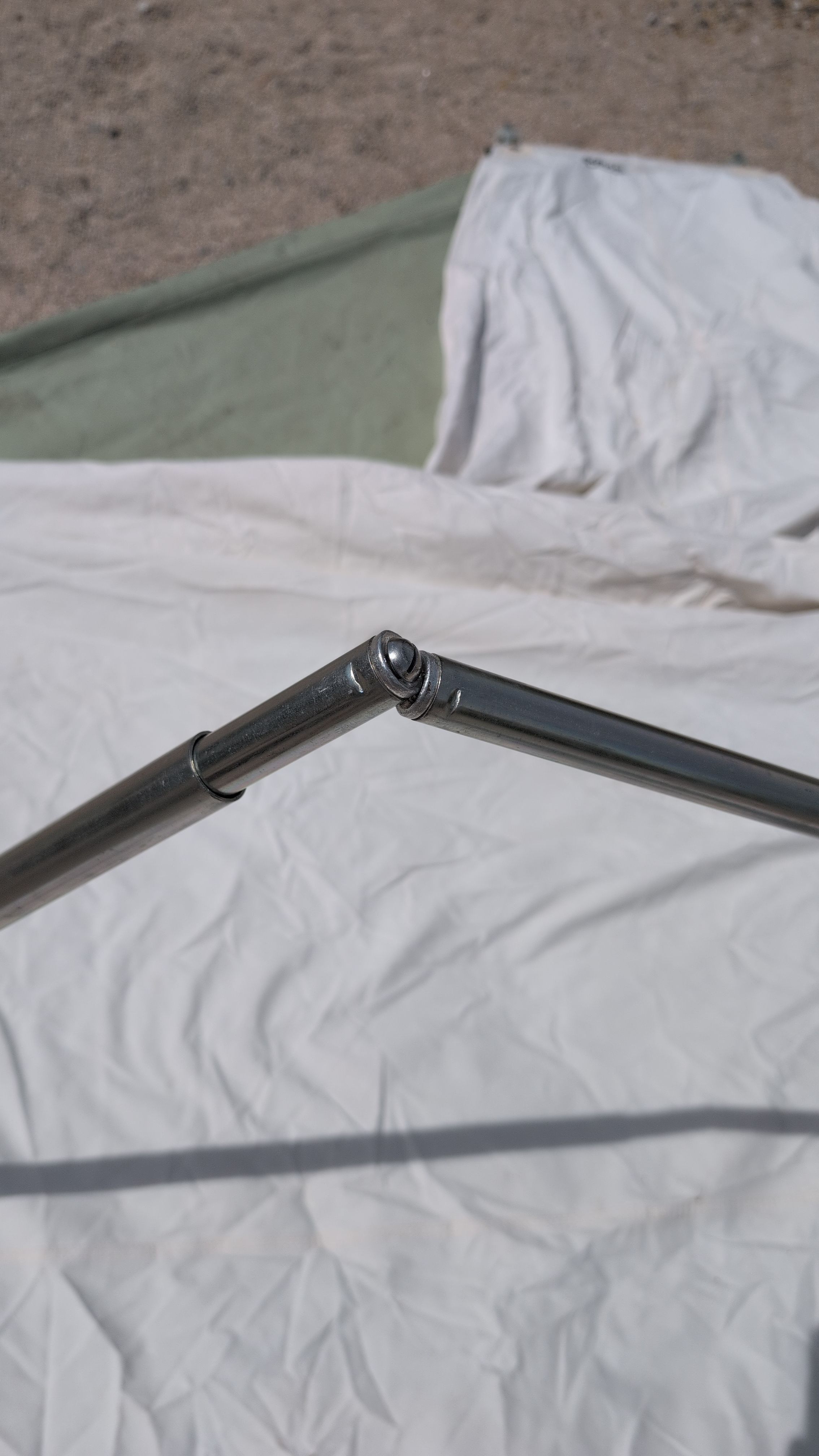 Photo of two middle crossbars being pushed together with bolt and concave aligned