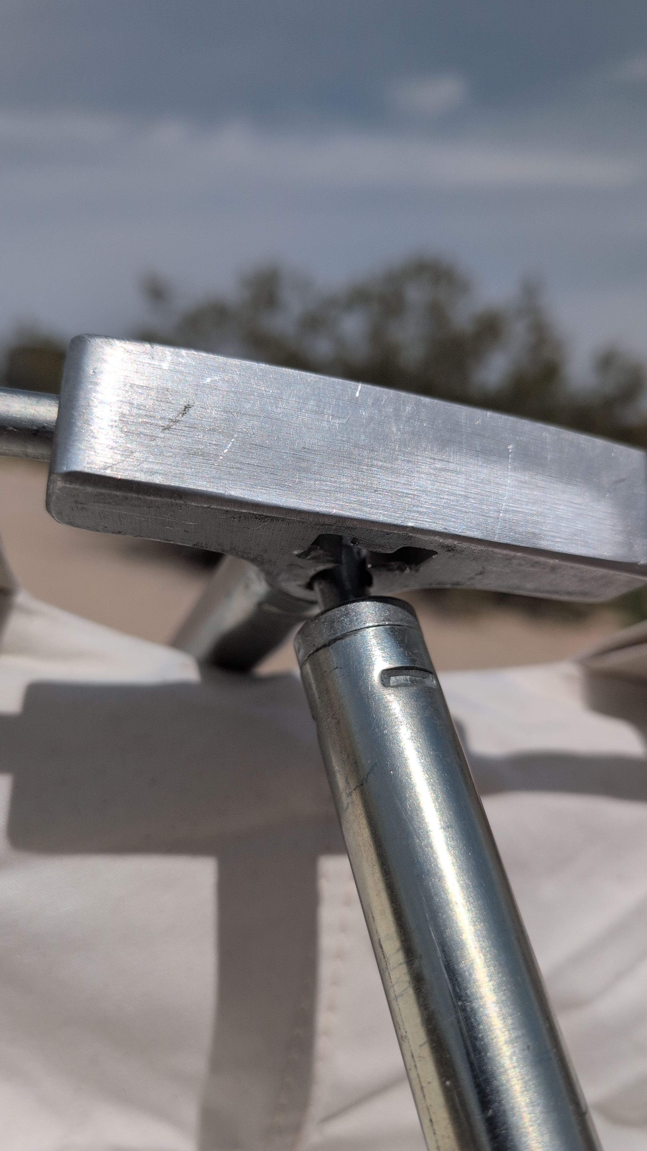 Photo of upright pole being inserted into grommet on underside of T-connector