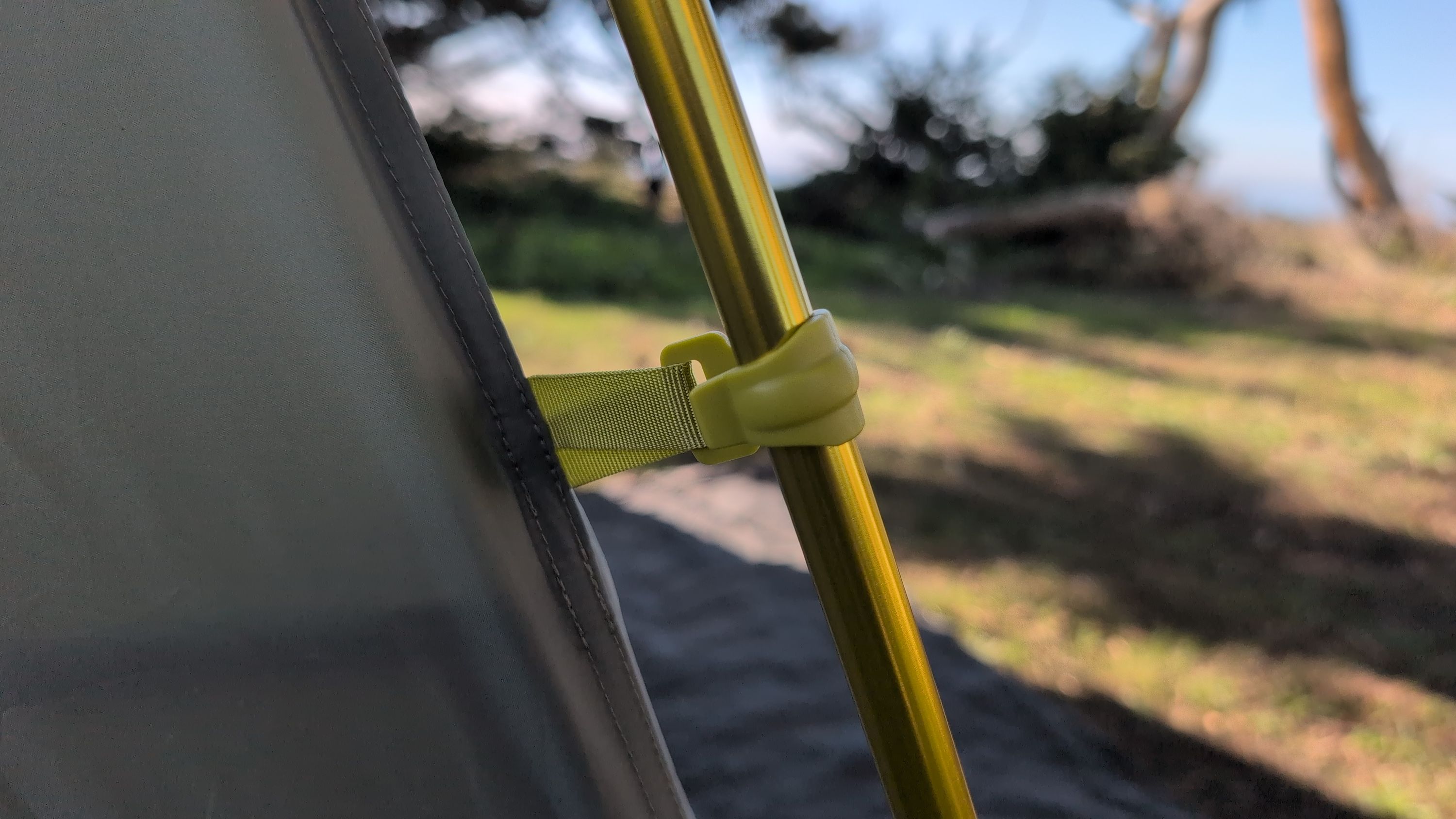 Close-up of plastic clip snapping onto a pole