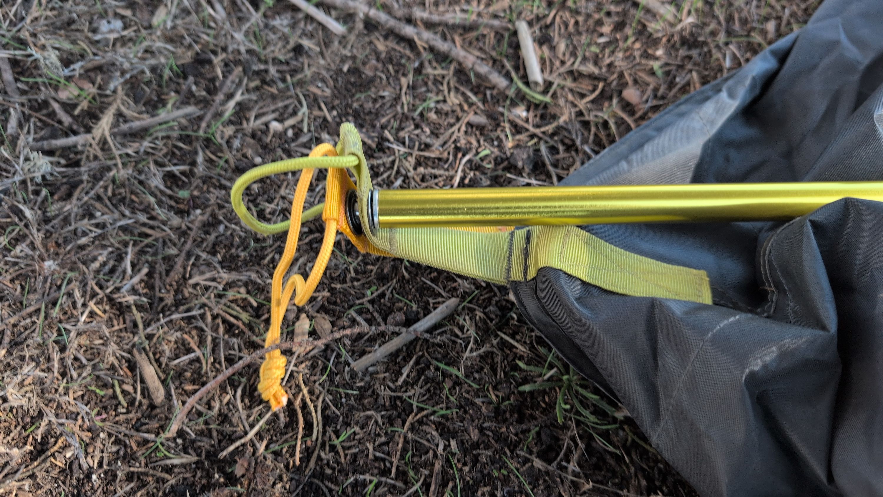 Close-up of pole end being inserted into corner grommet