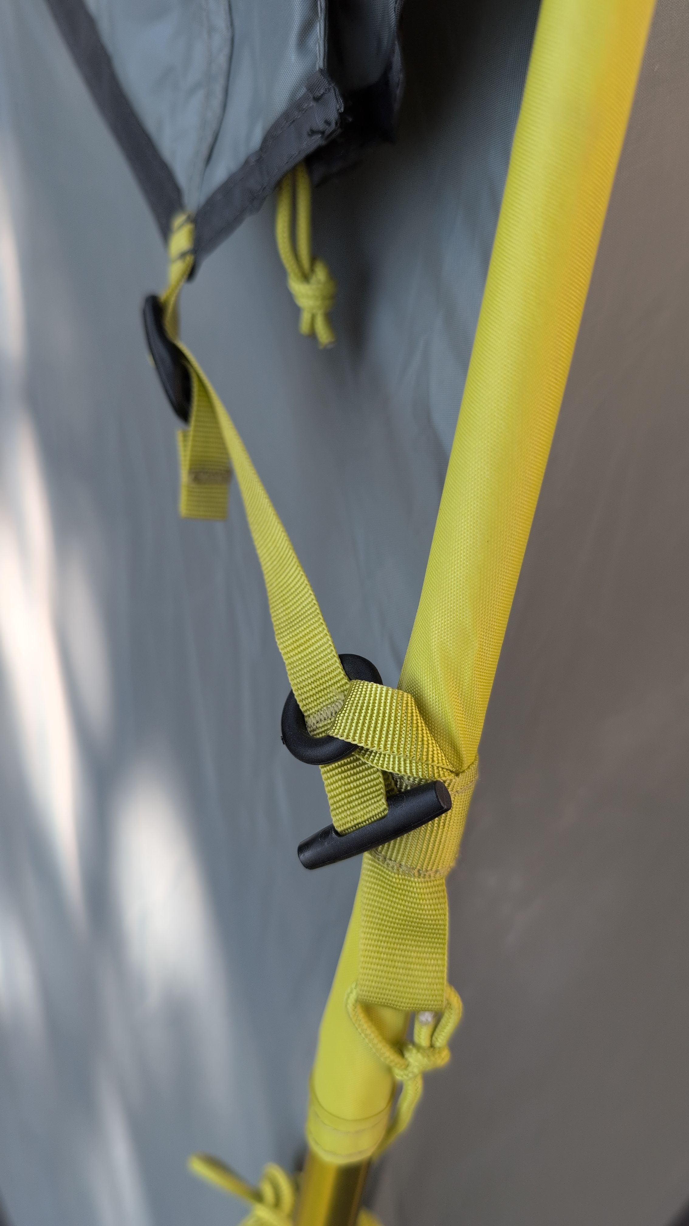 Close-up of toggle being threaded through back-corner ring