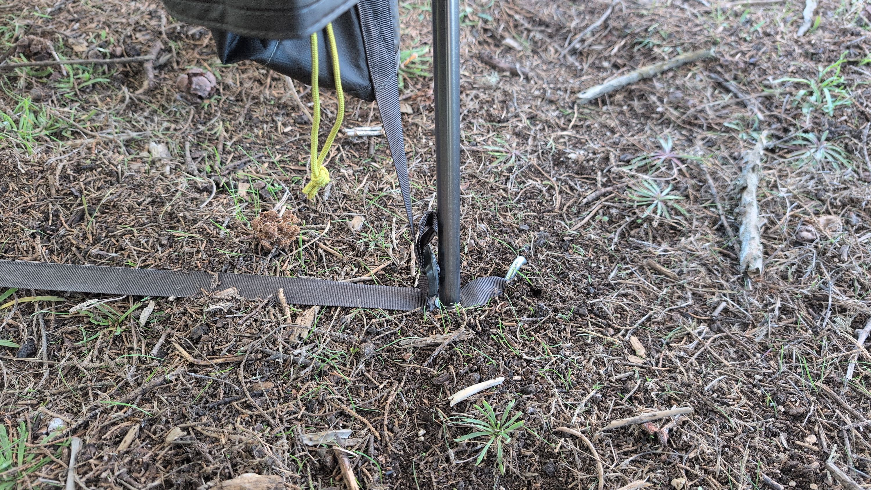 Close-up of vestibule pole end in grommet with stretchy strap