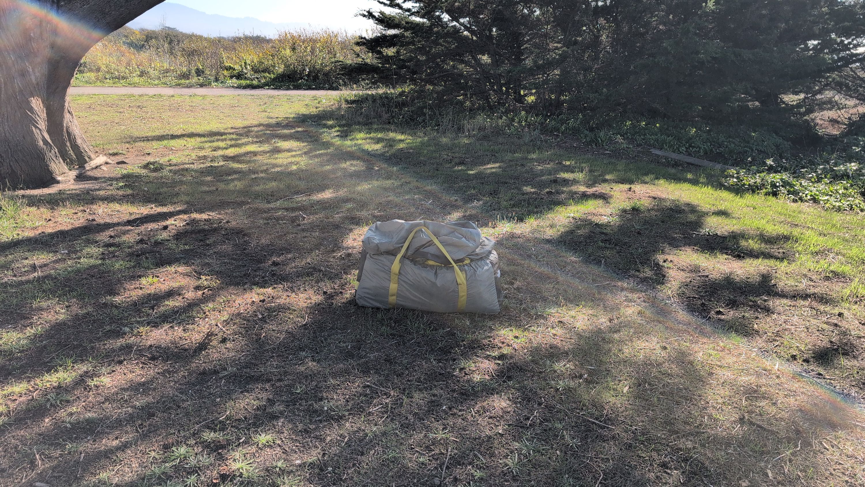 Photo of cleared campsite with tent bag for scale