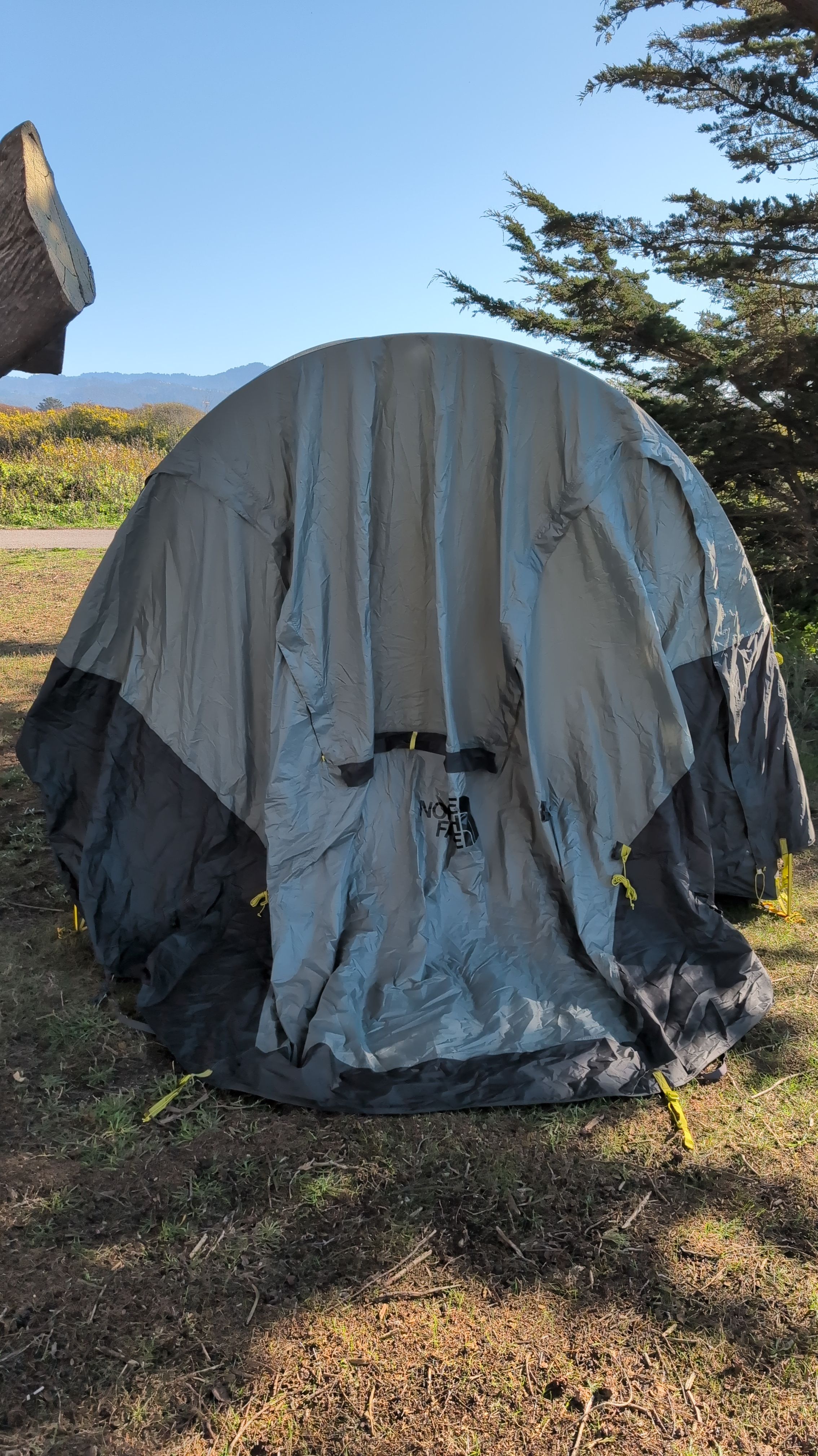 Photo of rain fly showing gray sleeve above logo on front side