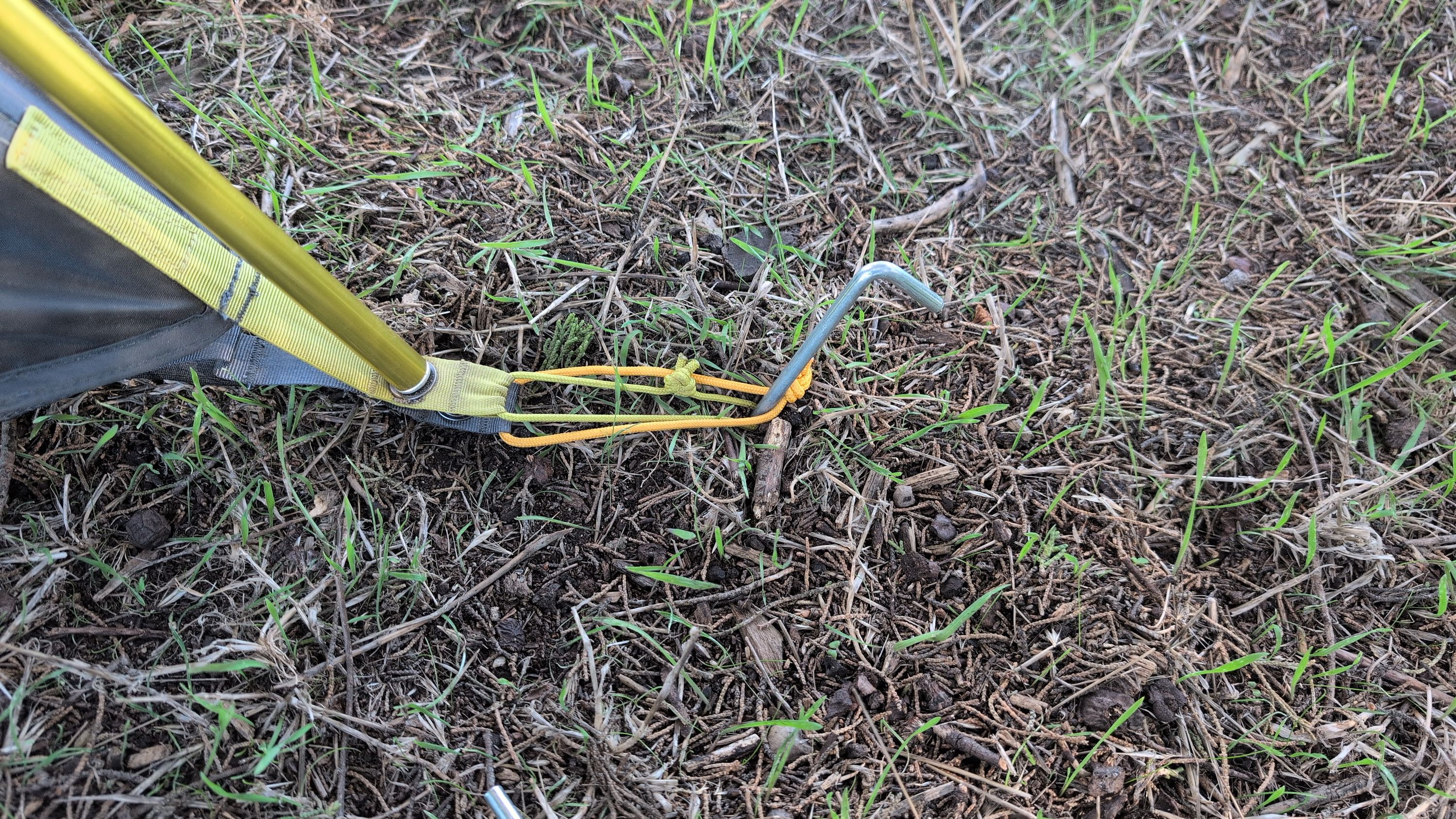 Photo of stake driven at tent corner