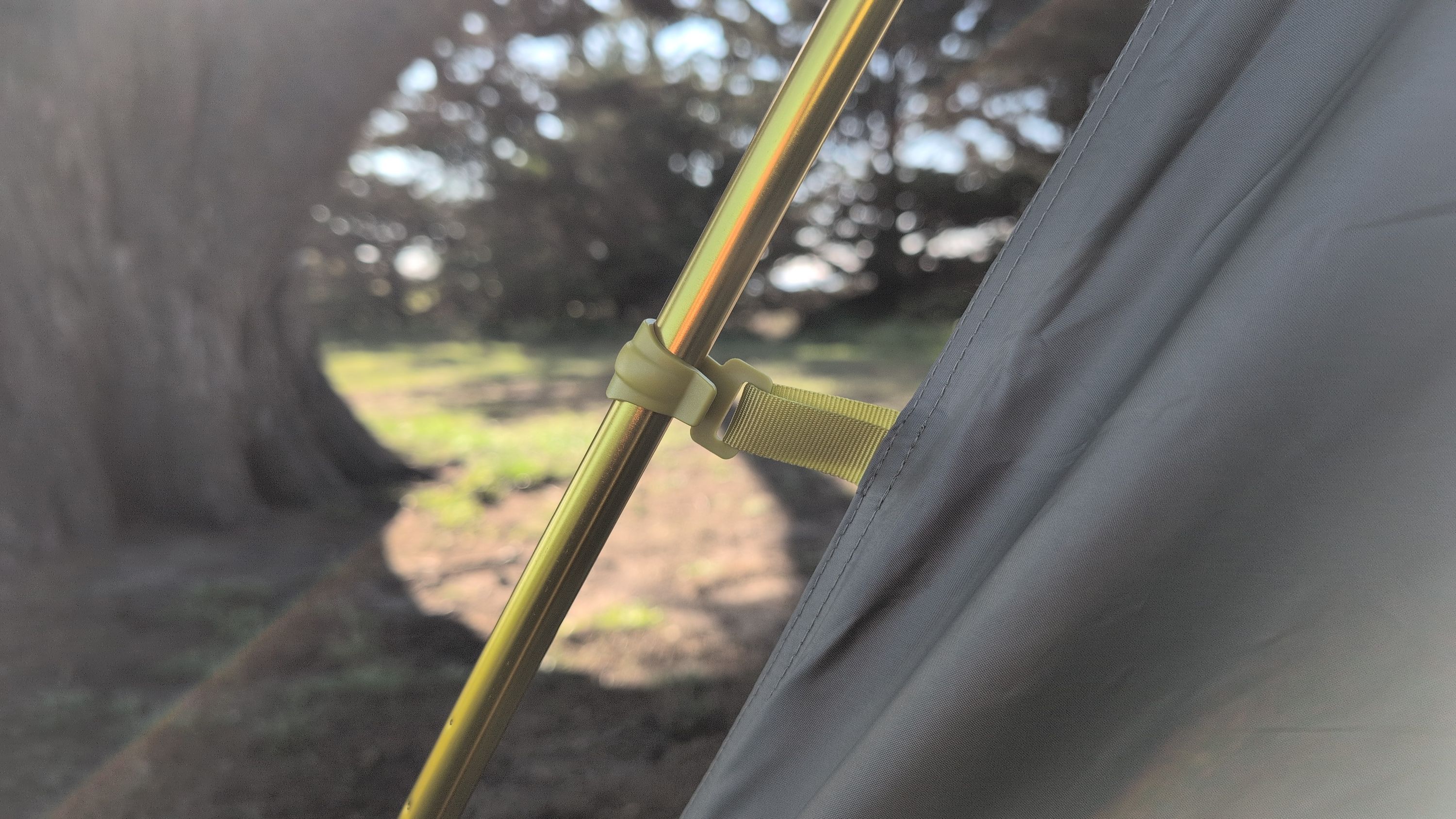 Close-up of plastic clip being attached to pole