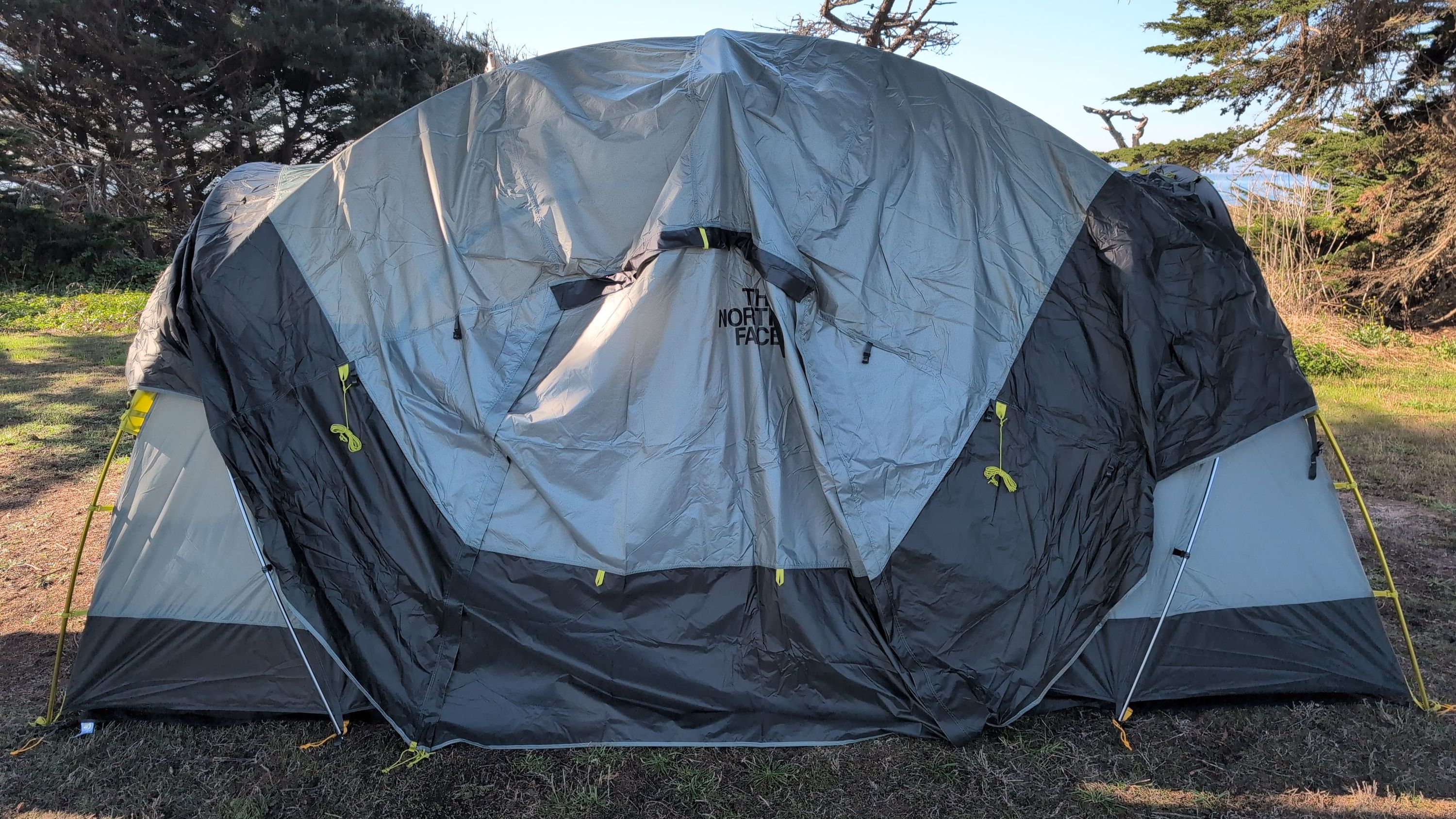 Photo of rain fly being draped over the tent