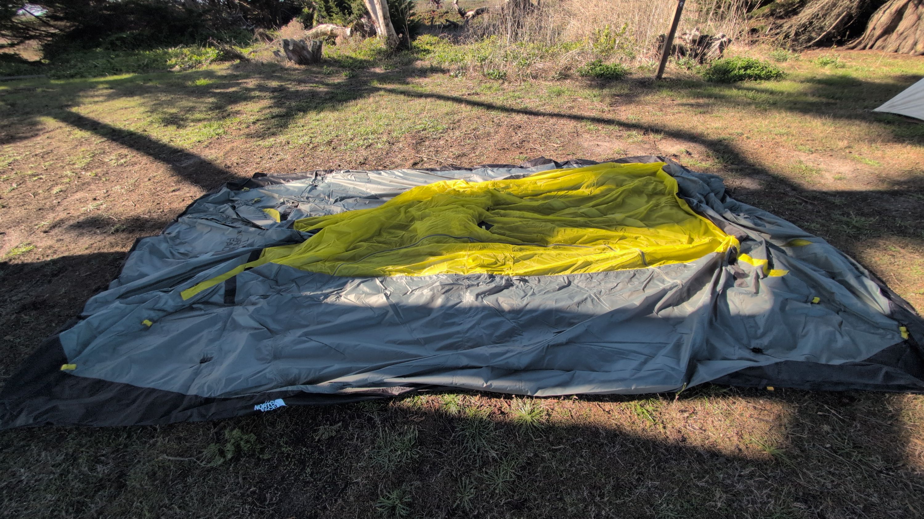 Photo of tent body spread flat on ground sheet with front door visible