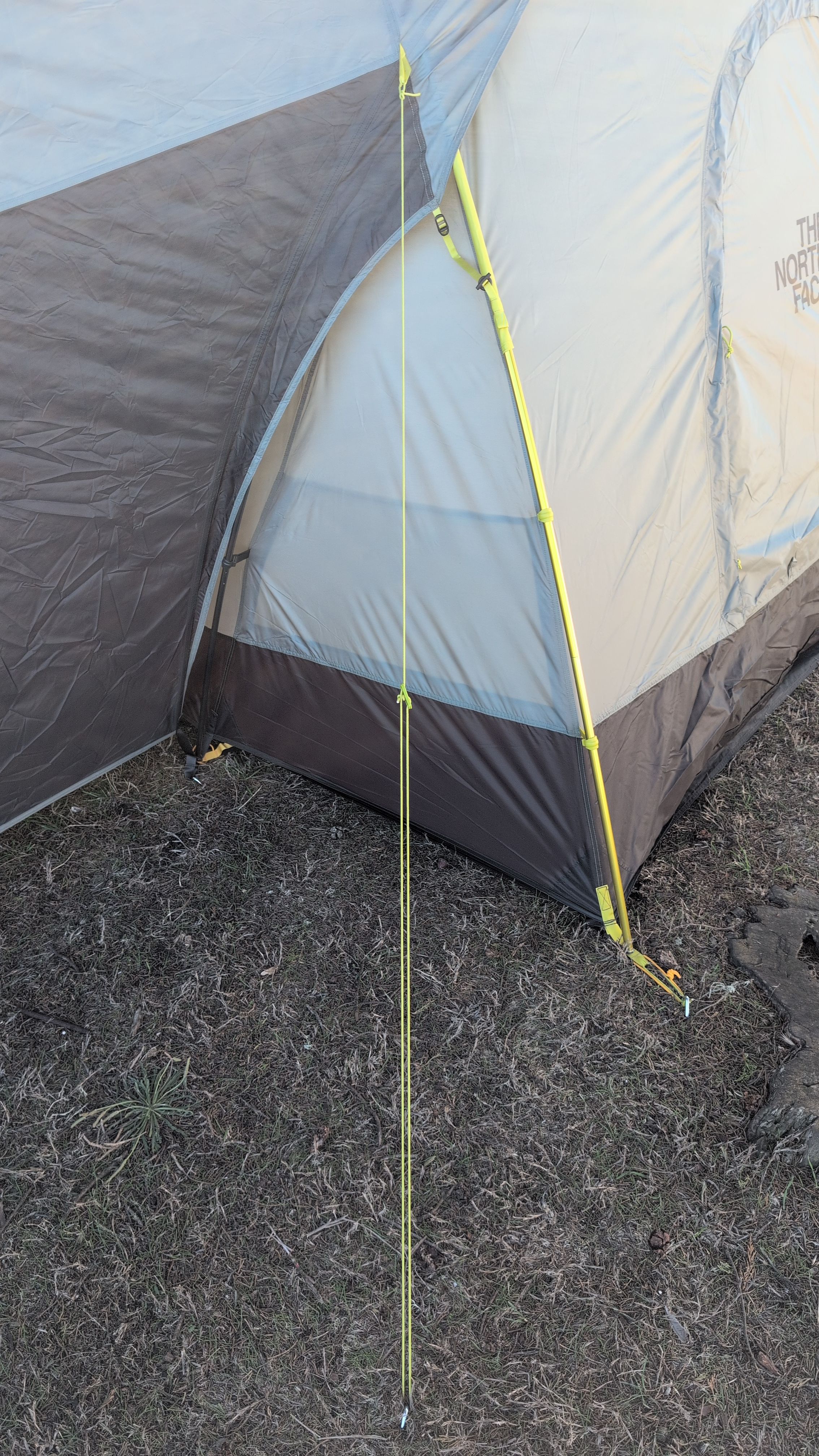 Photo showing guy line attached to fly loop and staked