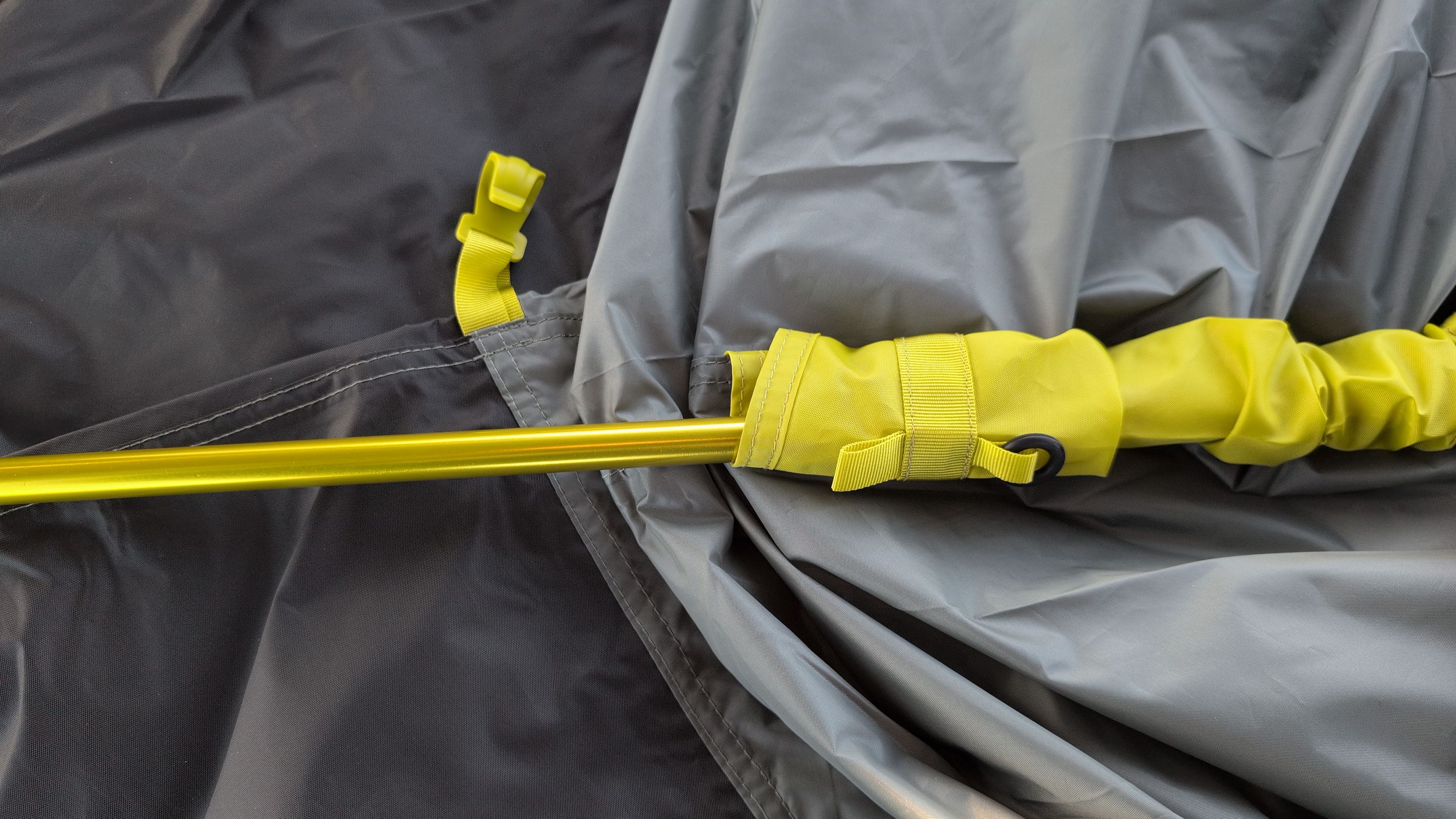 Photo showing pole being threaded through yellow-marked sleeve