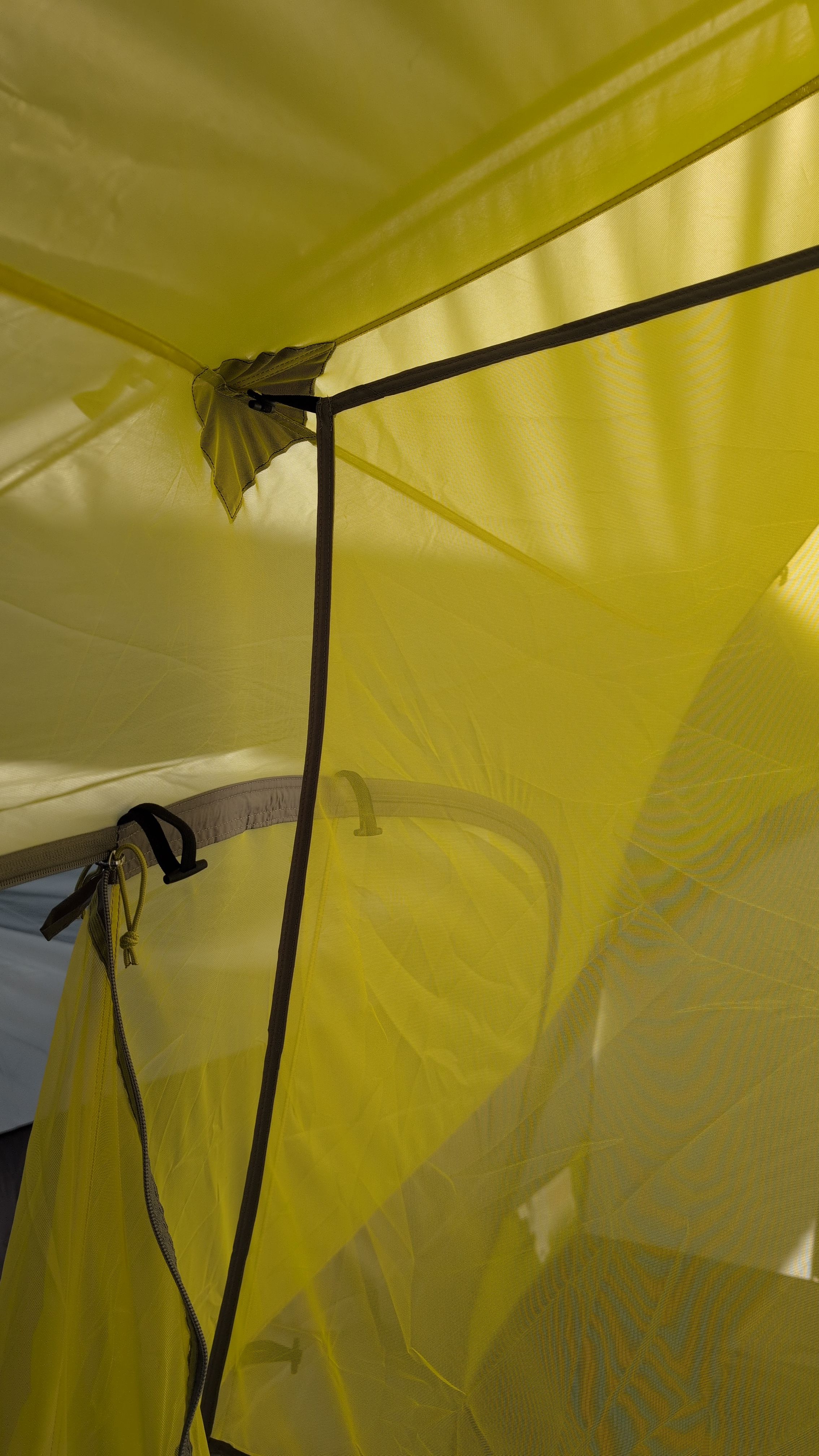 Photo showing room divider installed inside tent